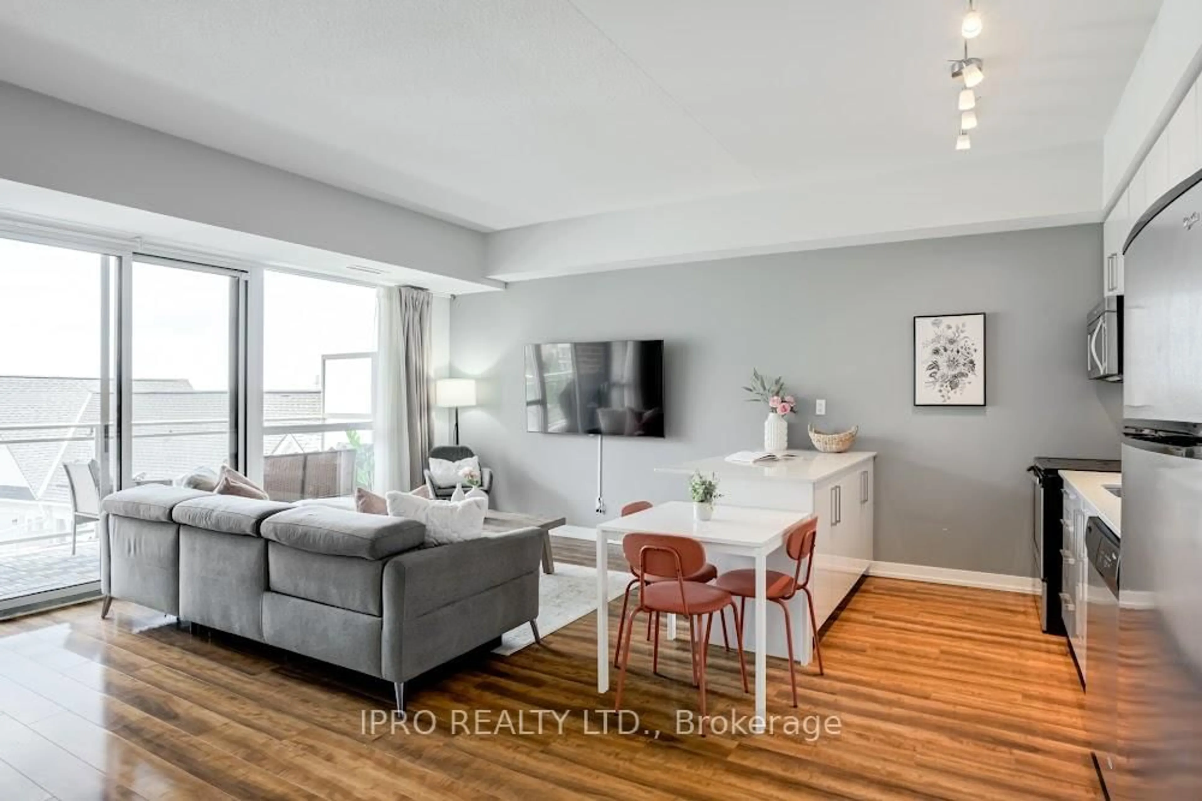 Living room with furniture, wood/laminate floor for 5101 Dundas St #406, Toronto Ontario M9A 5G8