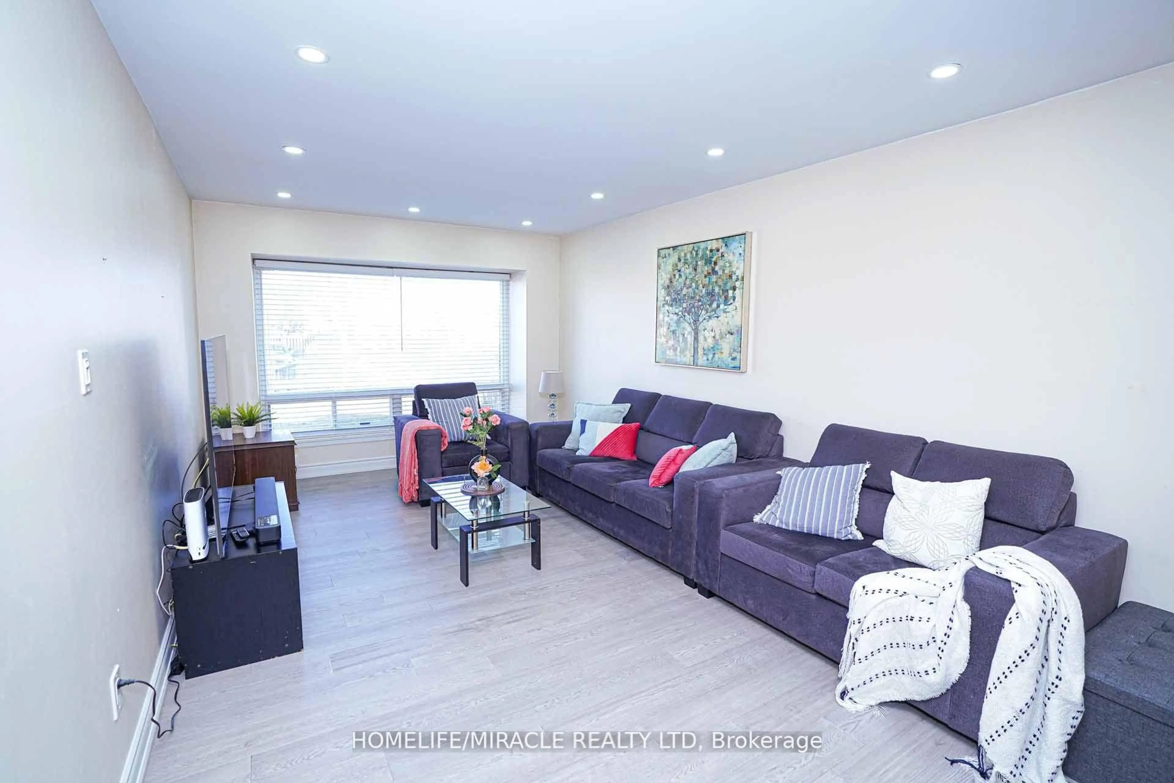 Living room with furniture, wood/laminate floor for 88 Goldcrest Rd, Brampton Ontario L6S 1G8