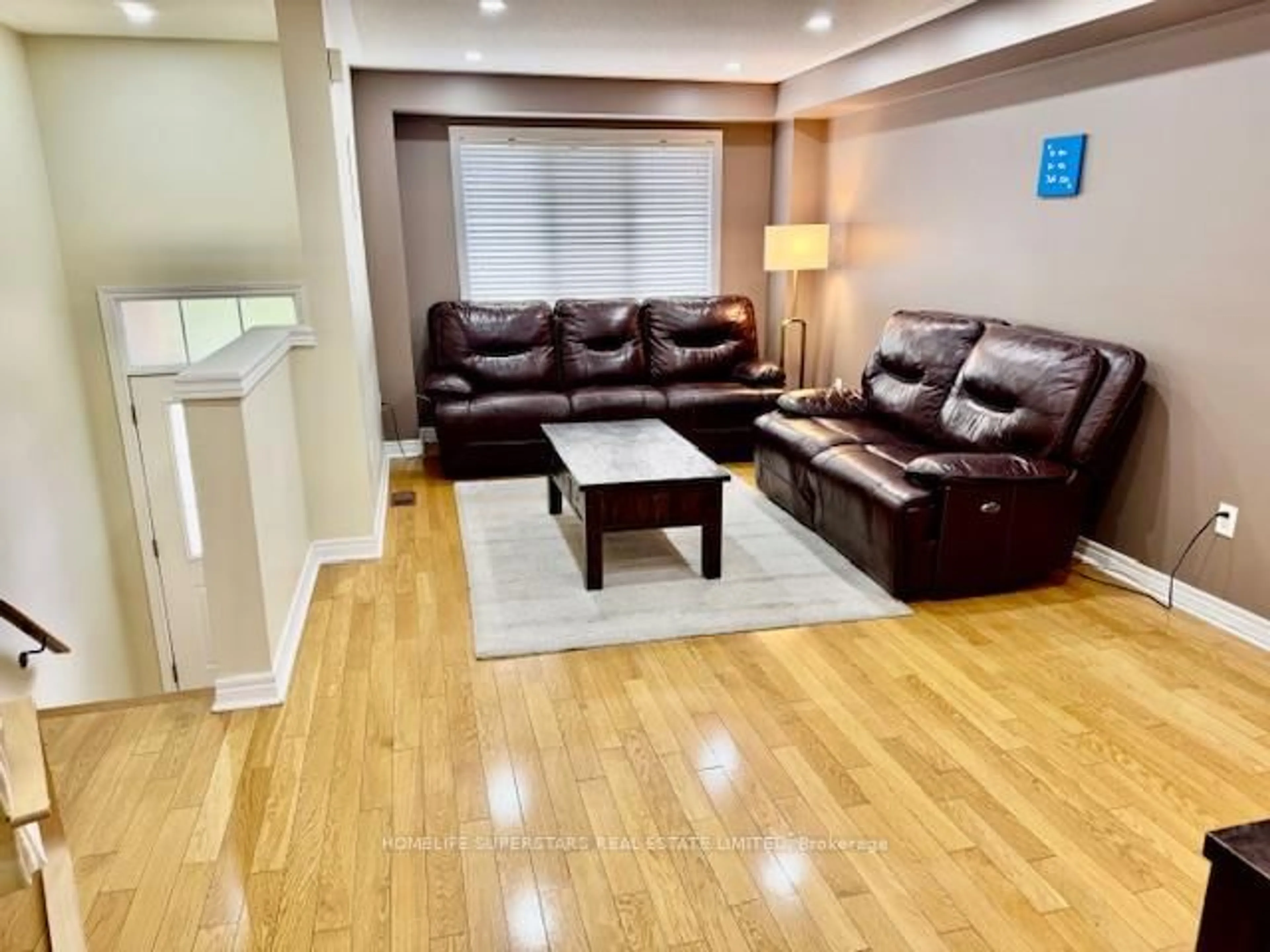 Living room with furniture, wood/laminate floor for 4950 Albina Way #77, Mississauga Ontario L4Z 4J5
