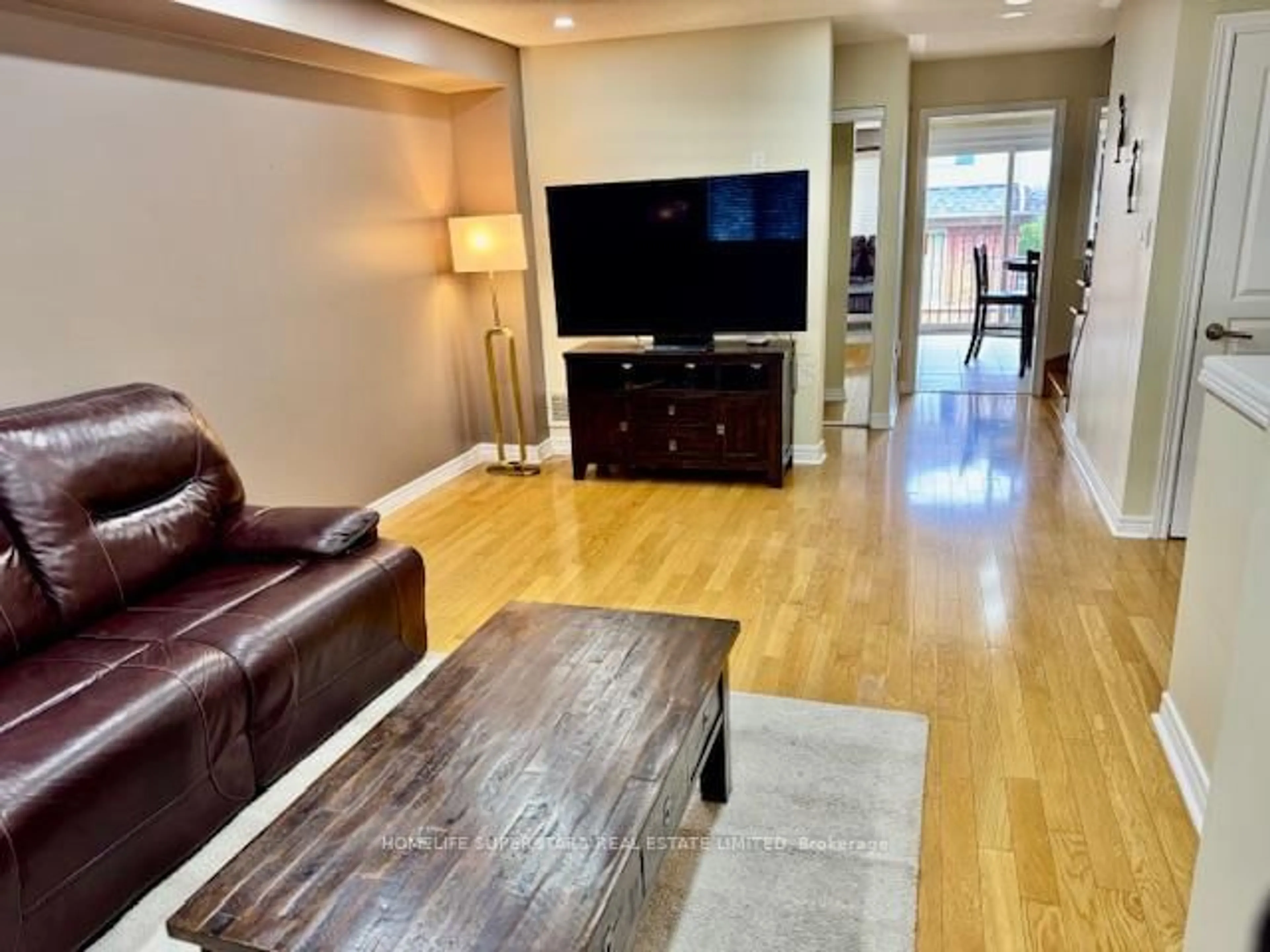 Living room with furniture, wood/laminate floor for 4950 Albina Way #77, Mississauga Ontario L4Z 4J5