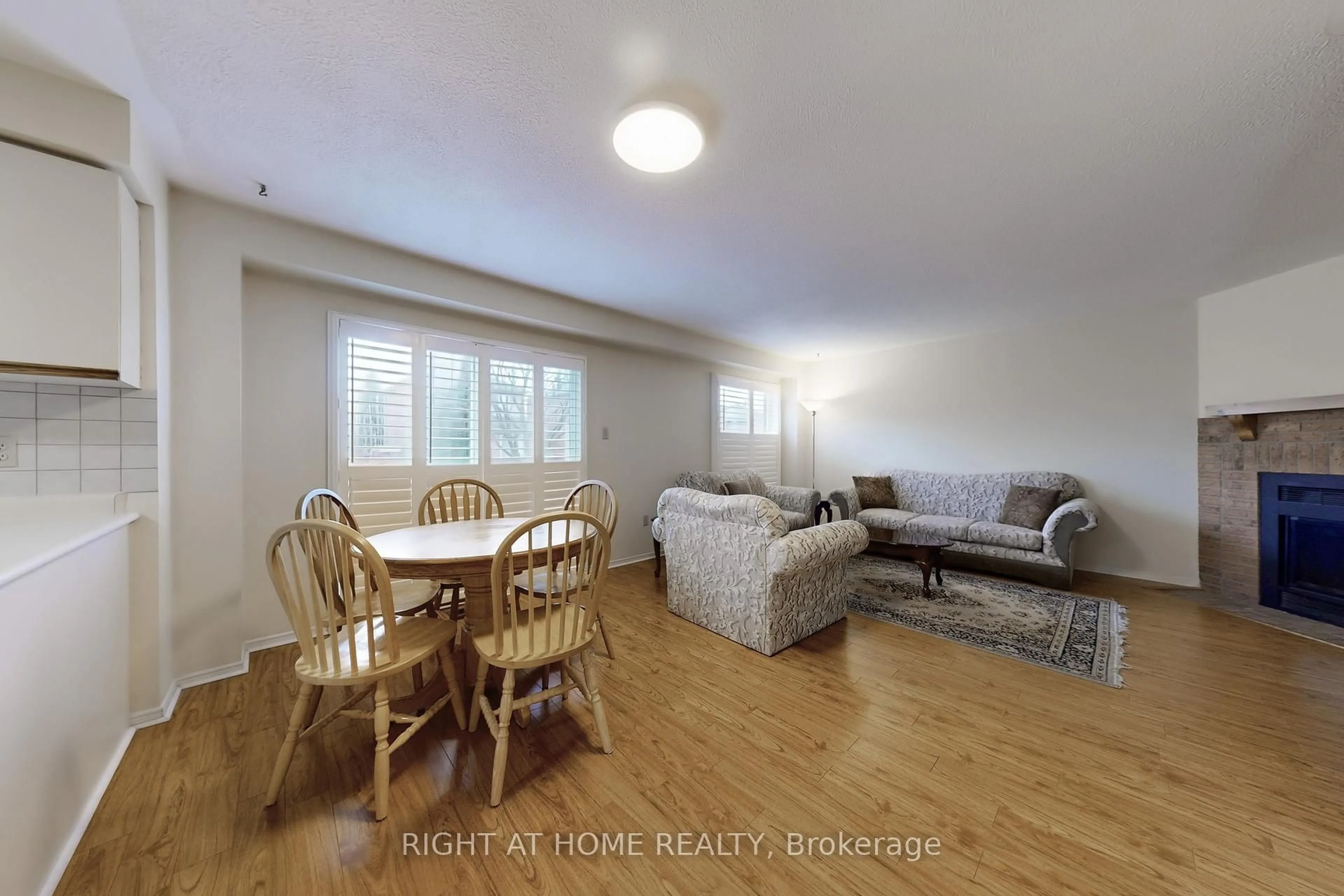 Living room with furniture, wood/laminate floor for 23 Duggan Dr, Brampton Ontario L6Y 4H9