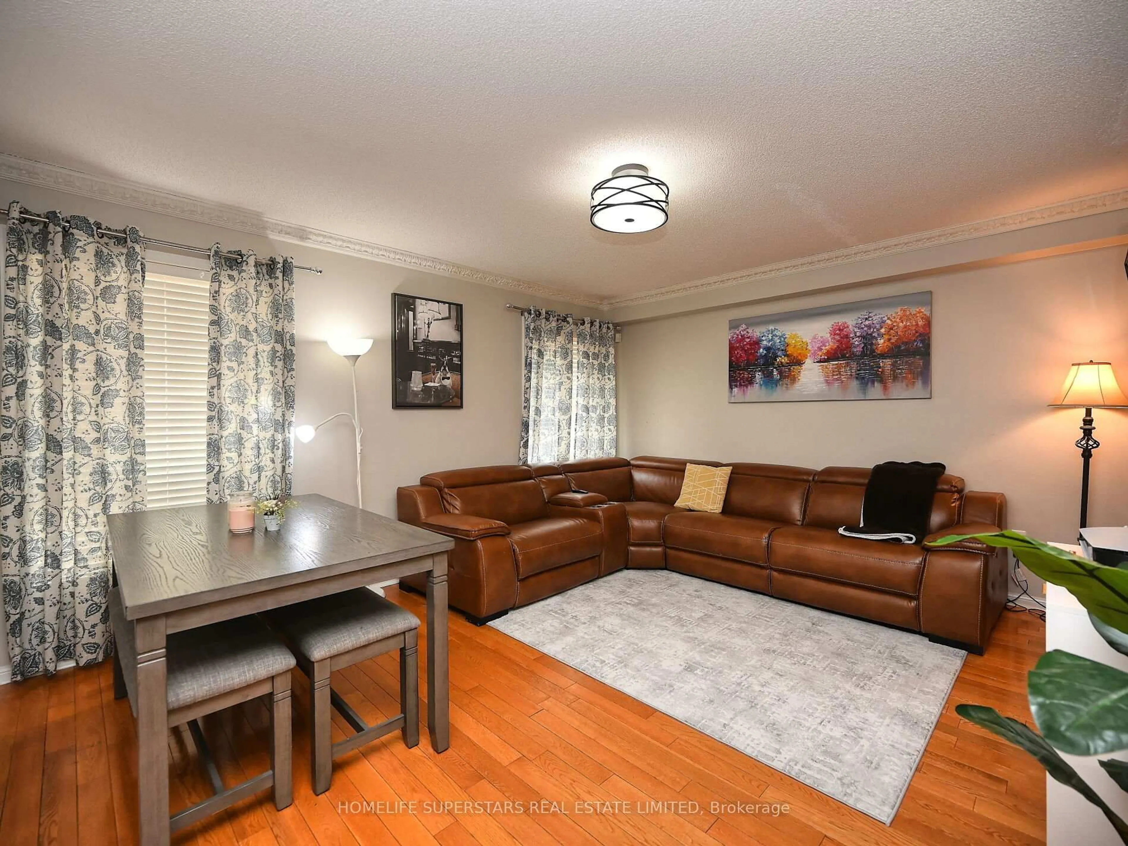 Living room with furniture, wood/laminate floor for 20 Marshmarigold Dr, Brampton Ontario L7A 2S7