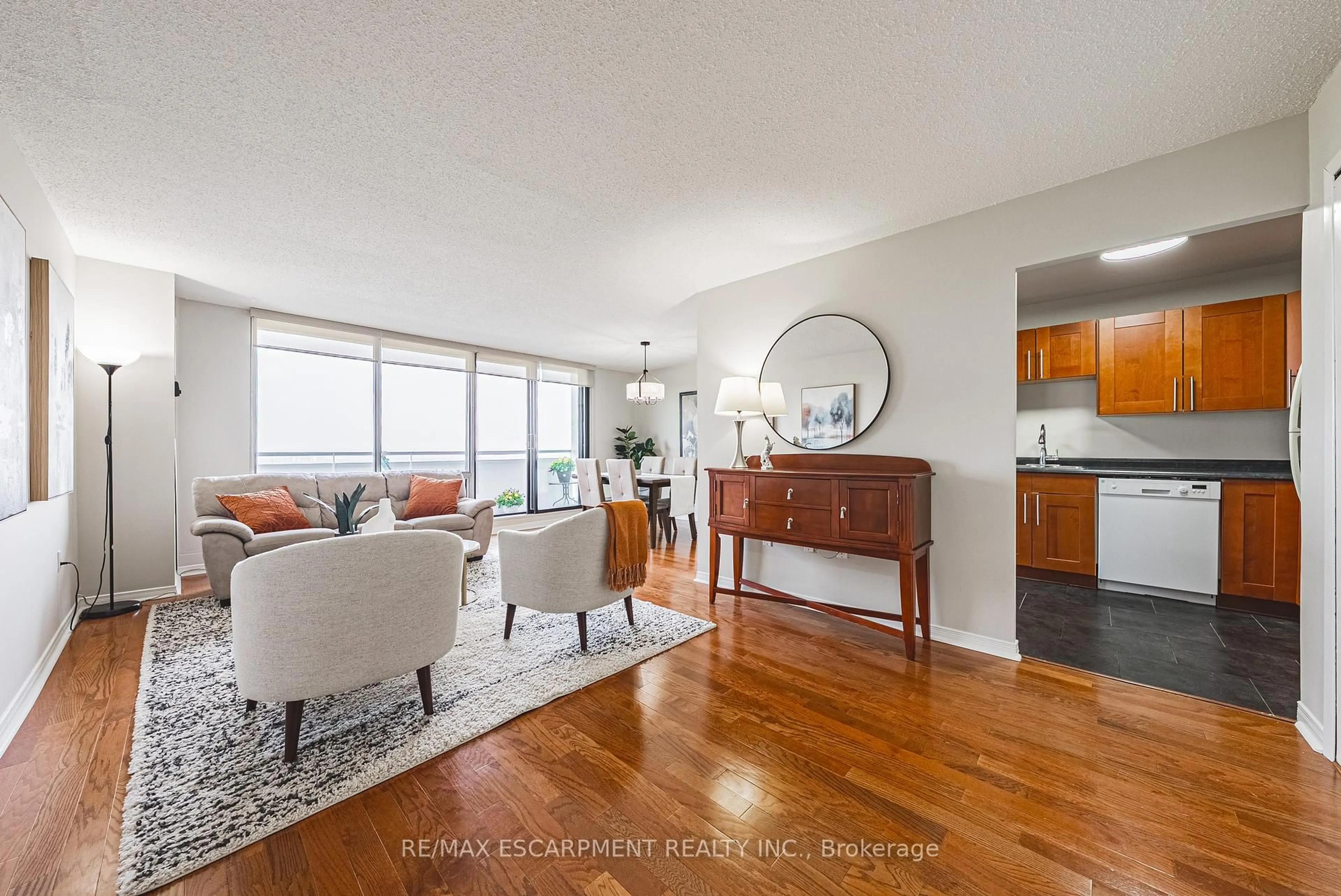 Living room with furniture, wood/laminate floor for 2055 Upper Middle Rd #1706, Burlington Ontario L7P 3P4