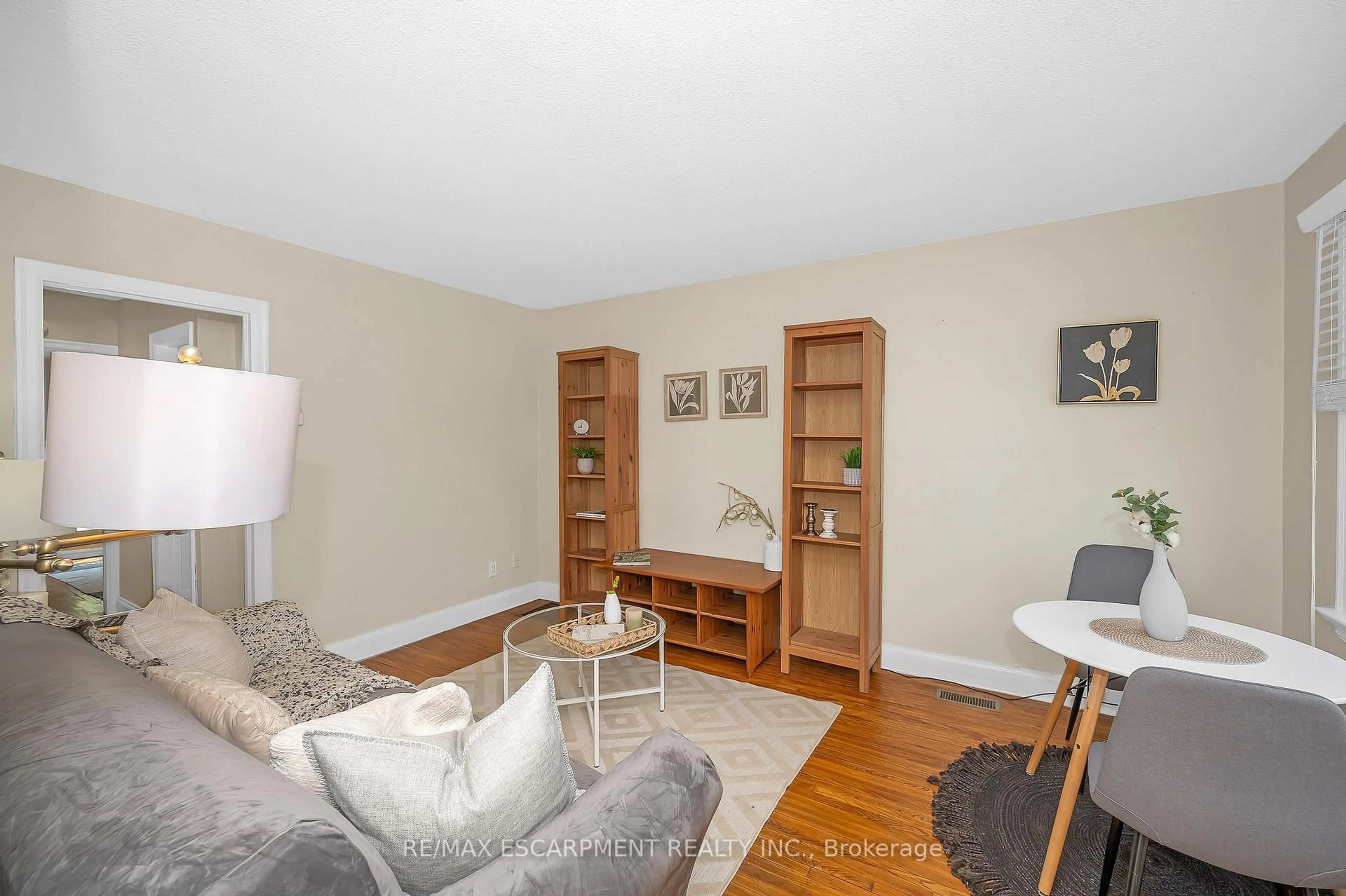 Living room with furniture, wood/laminate floor for 61 Struthers St, Toronto Ontario M8V 1Y2