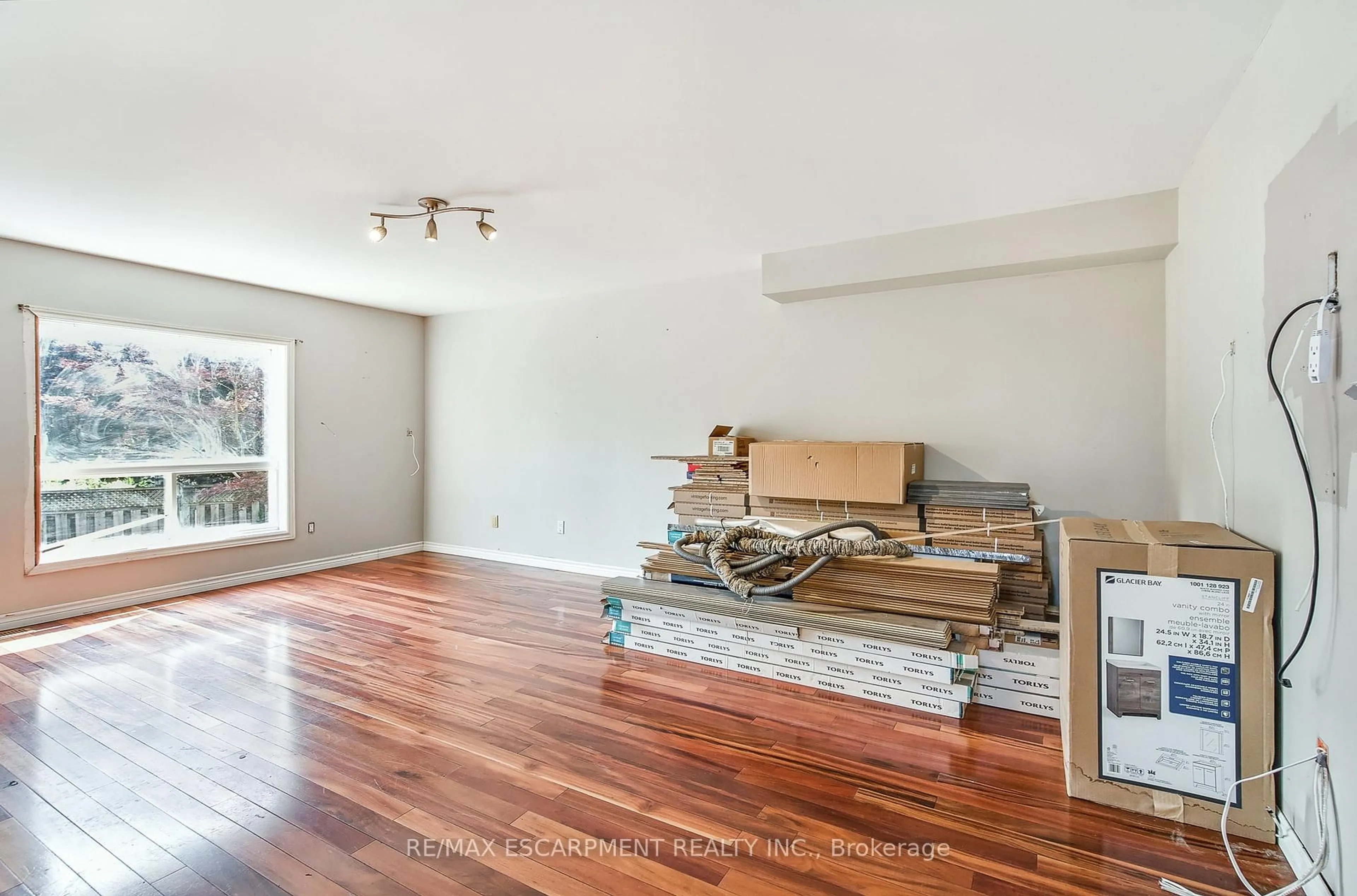 Living room with furniture, wood/laminate floor for 573 Enfield Rd, Burlington Ontario L7T 2X5