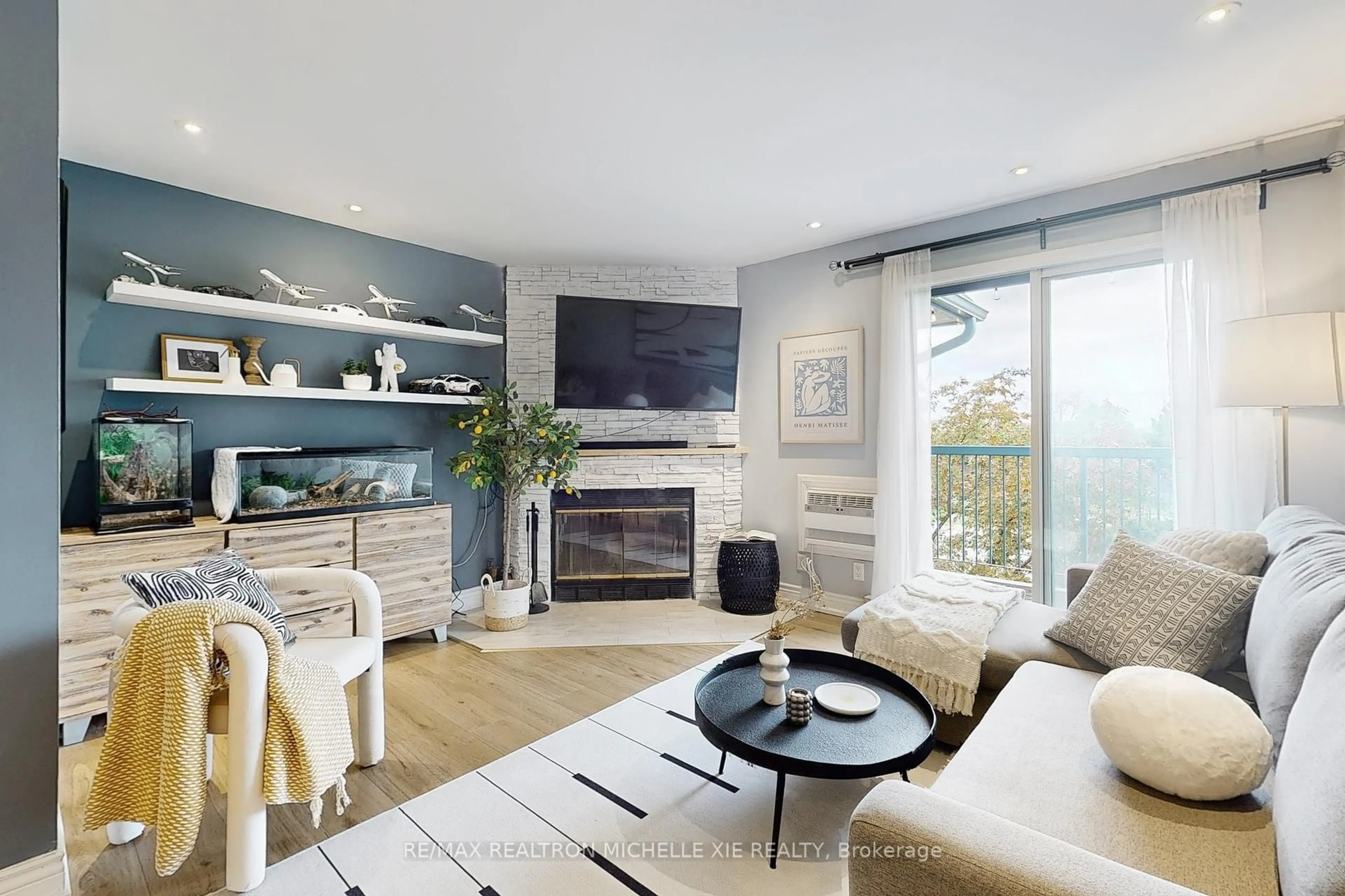 Living room with furniture, wood/laminate floor for 65 Trailwood Dr #133, Mississauga Ontario L4Z 3L1