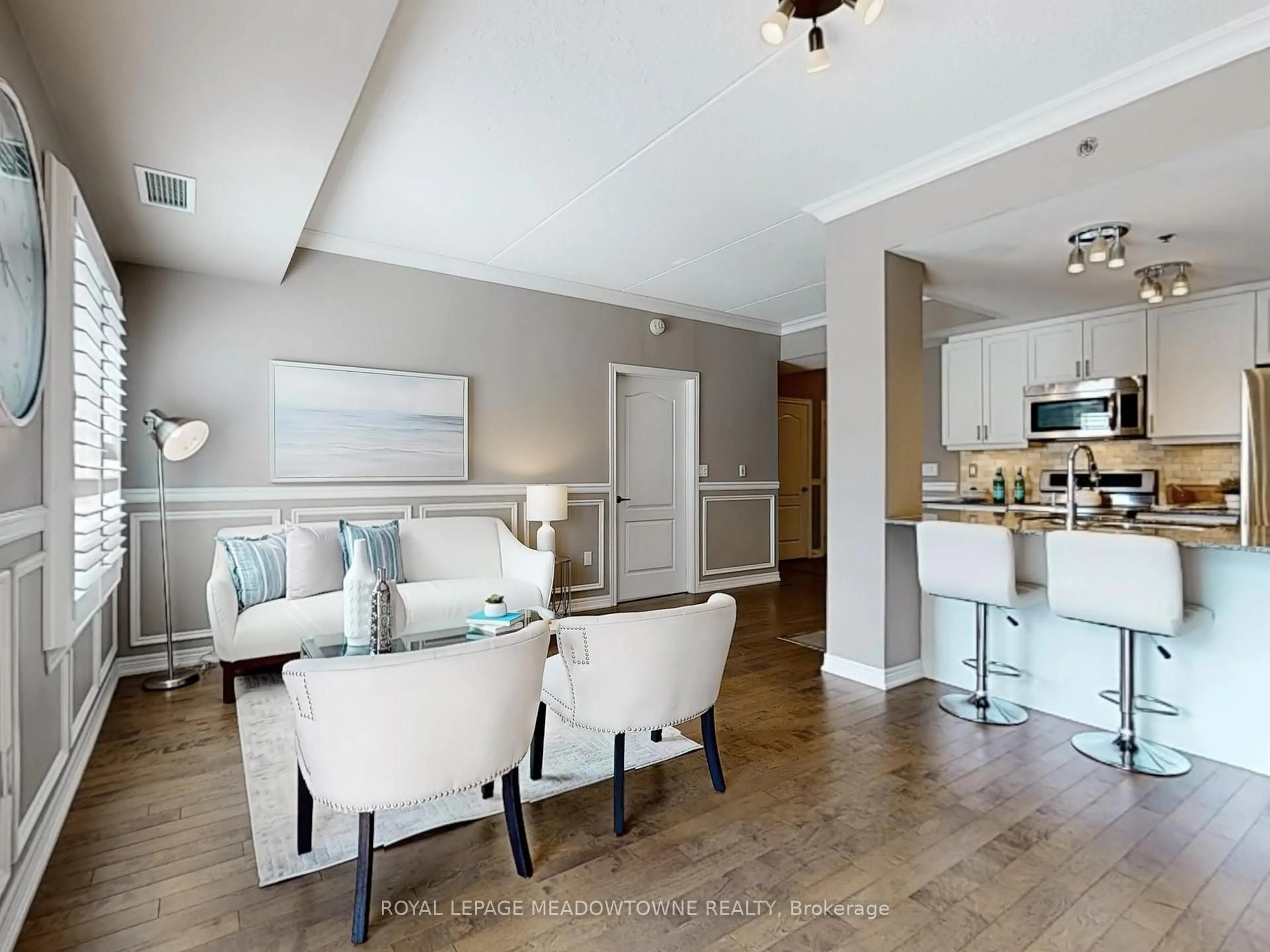 Living room with furniture, wood/laminate floor for 1421 Costigan Rd #202, Milton Ontario L9T 2N4