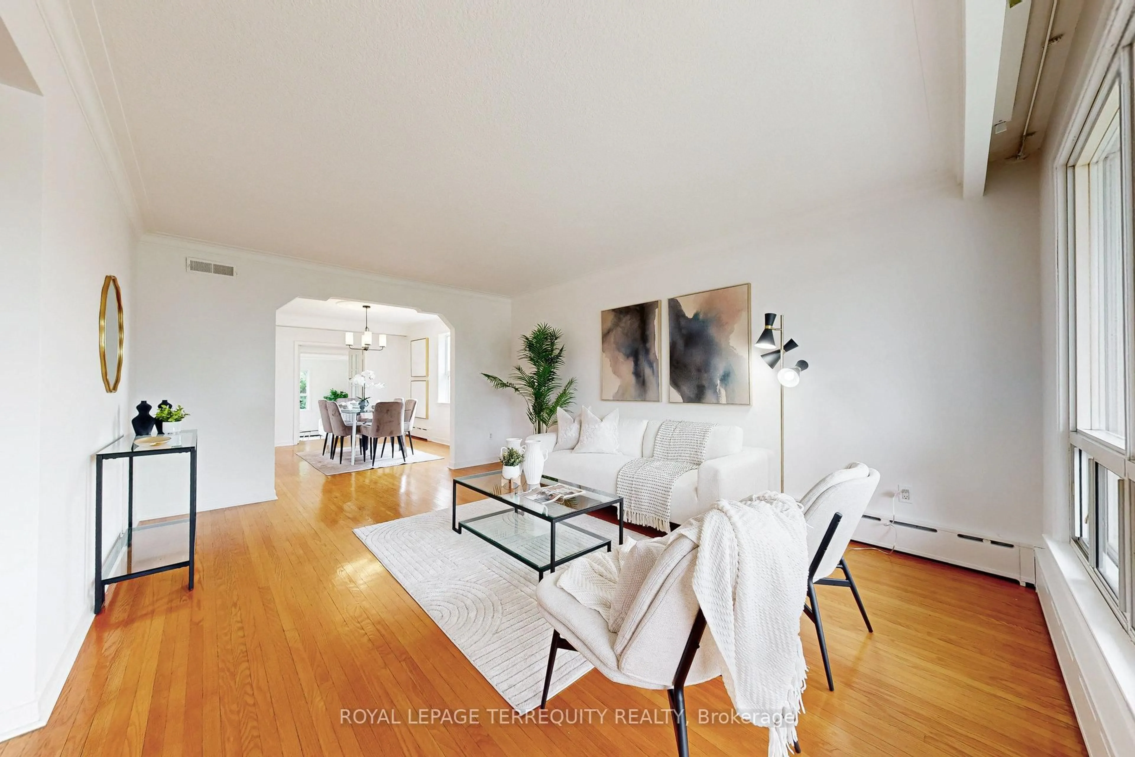 Living room with furniture, wood/laminate floor for 211 Rustic Rd, Toronto Ontario M6L 1W3