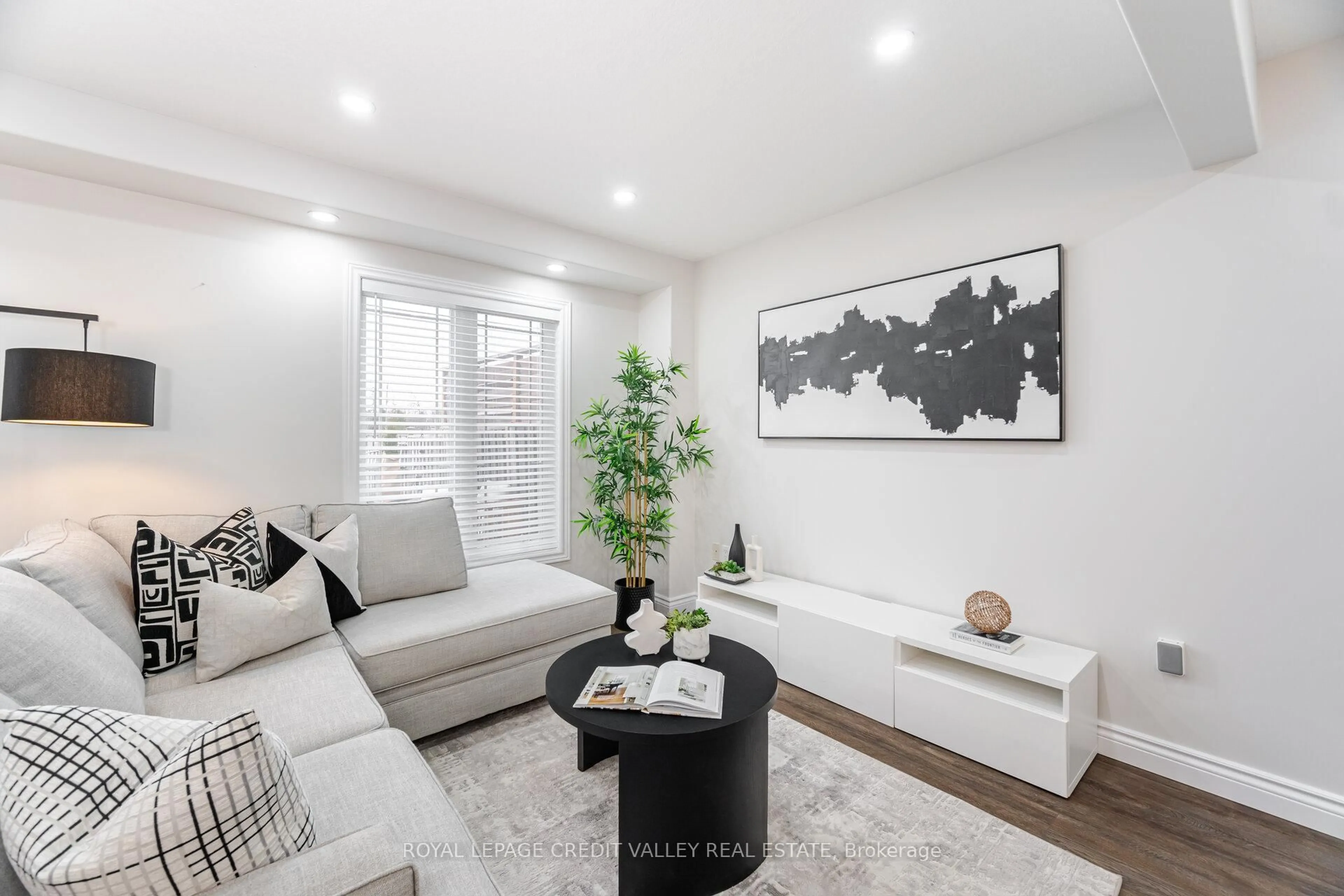 Living room with furniture, wood/laminate floor for 152 Preston Dr, Orangeville Ontario L9W 0C9