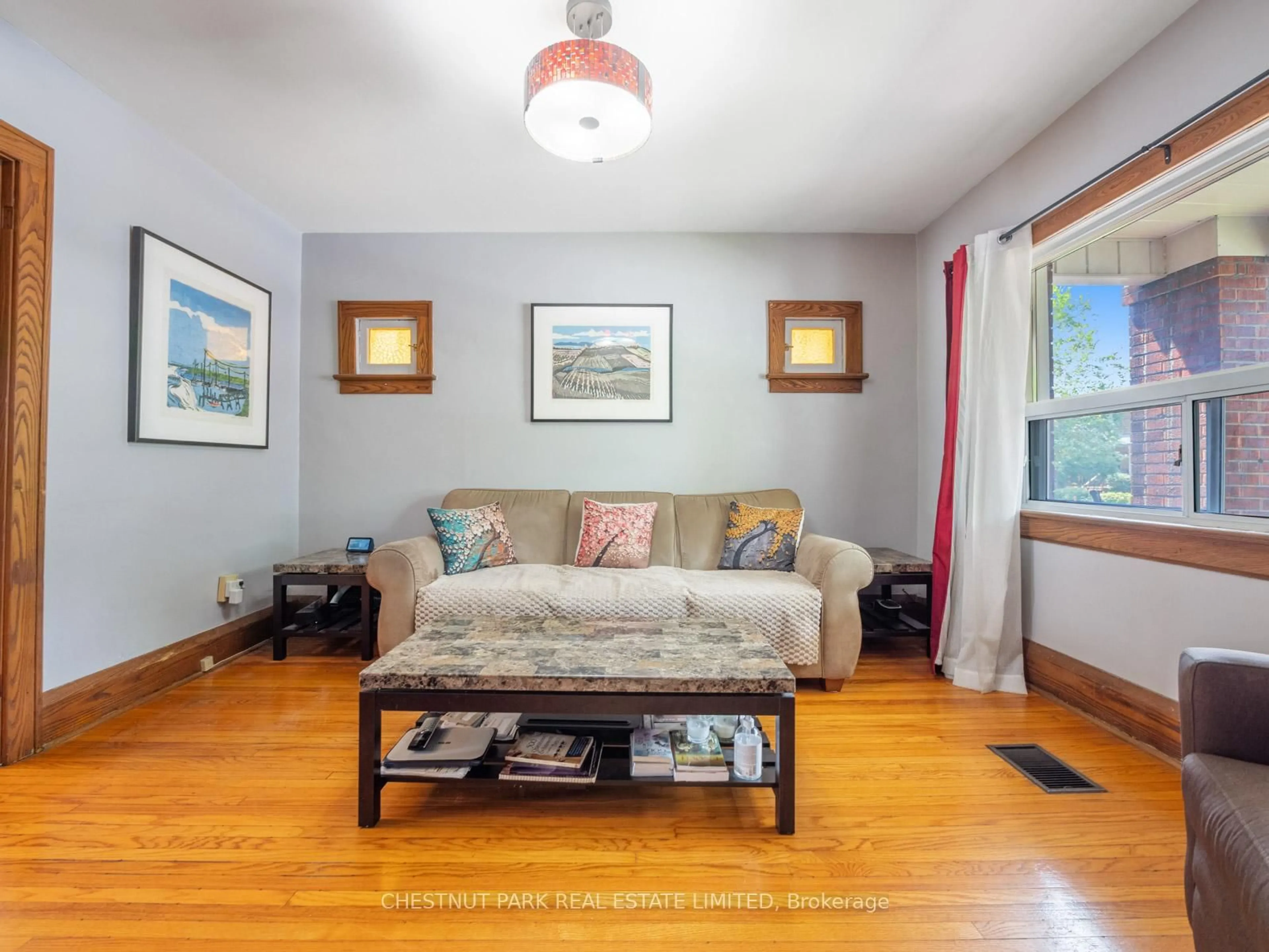 Living room with furniture, wood/laminate floor for 673 Durie St, Toronto Ontario M6S 3H4
