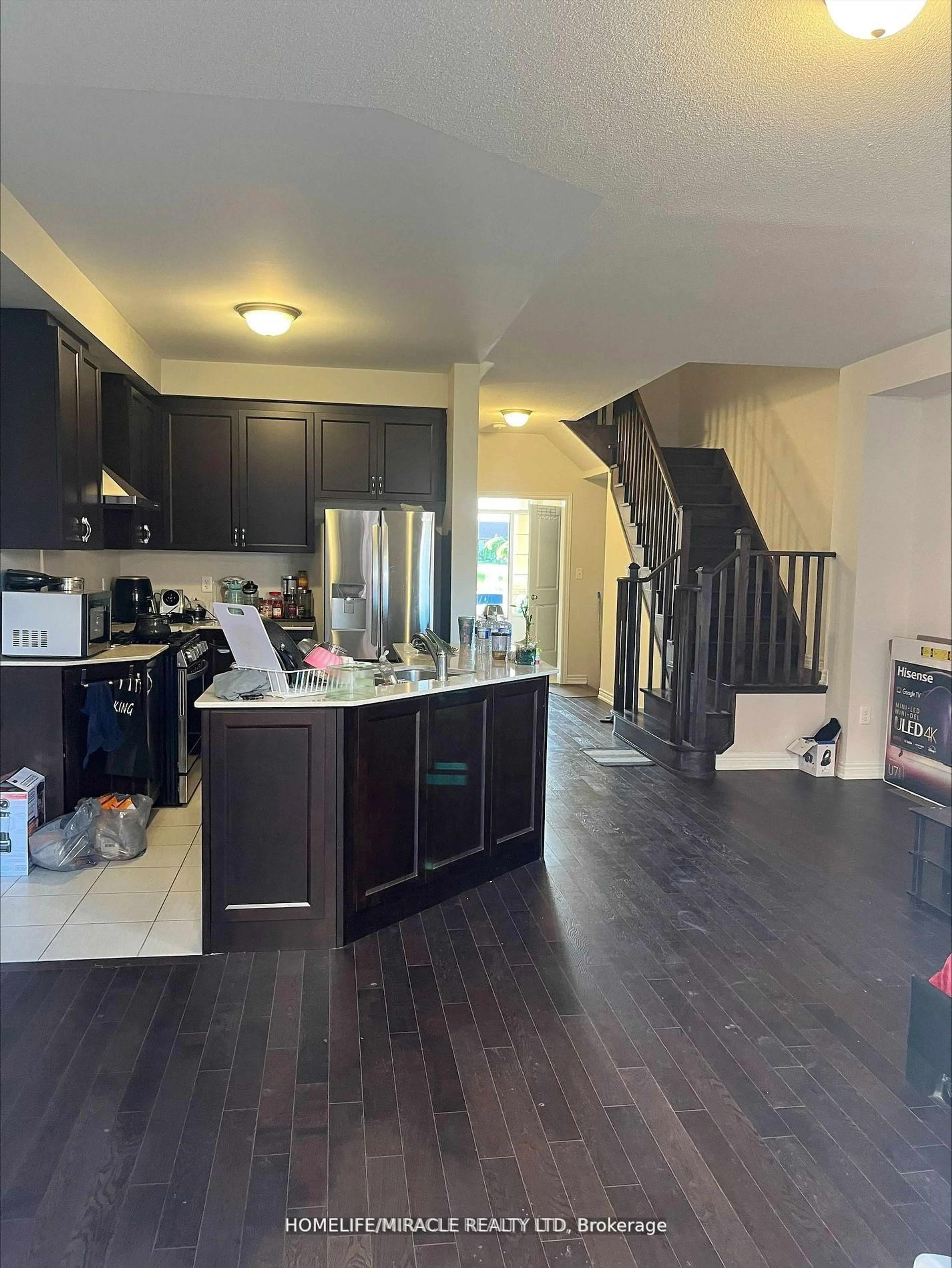 Open concept kitchen, wood/laminate floor for 27 Bushwood Tr, Brampton Ontario L7A 5J7