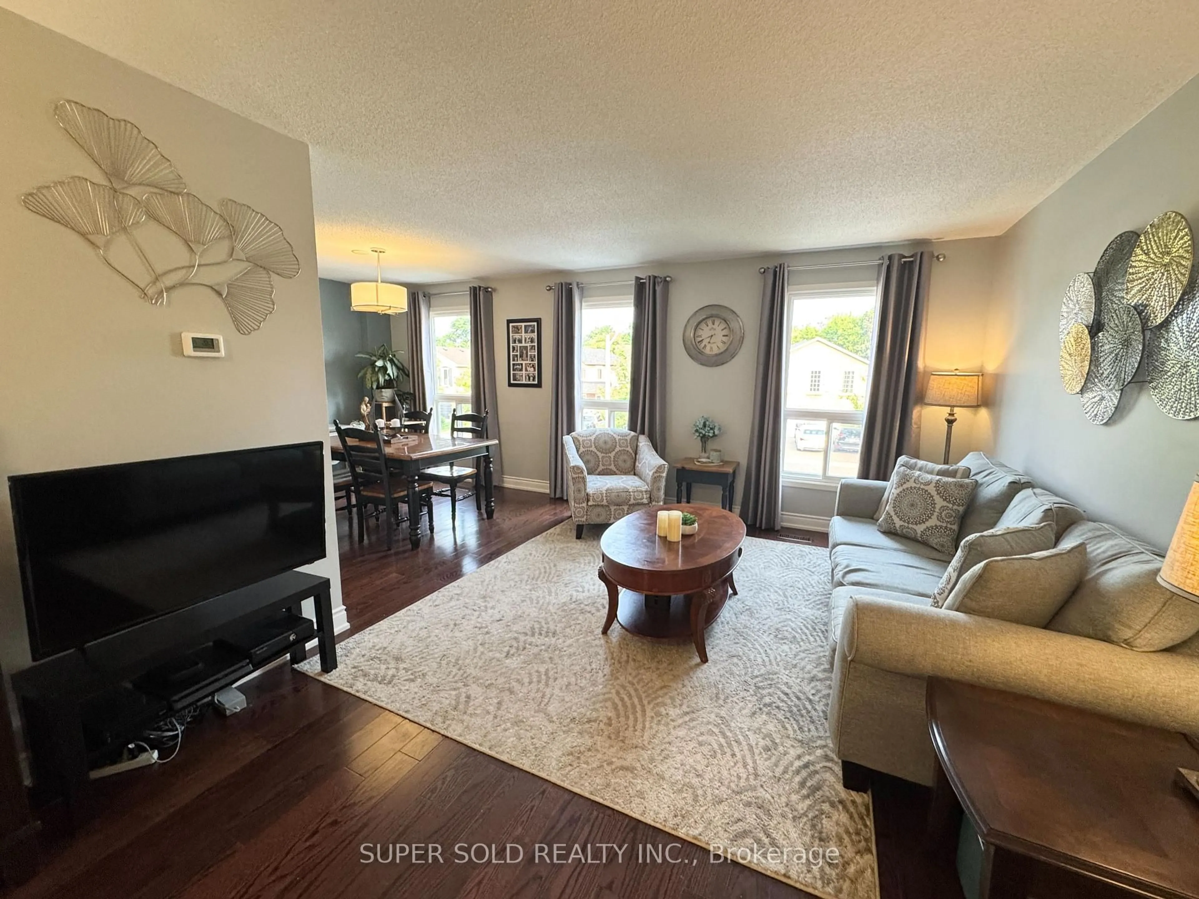 Living room with furniture, wood/laminate floor for 25 Floribunda Cres, Brampton Ontario L6T 4R8