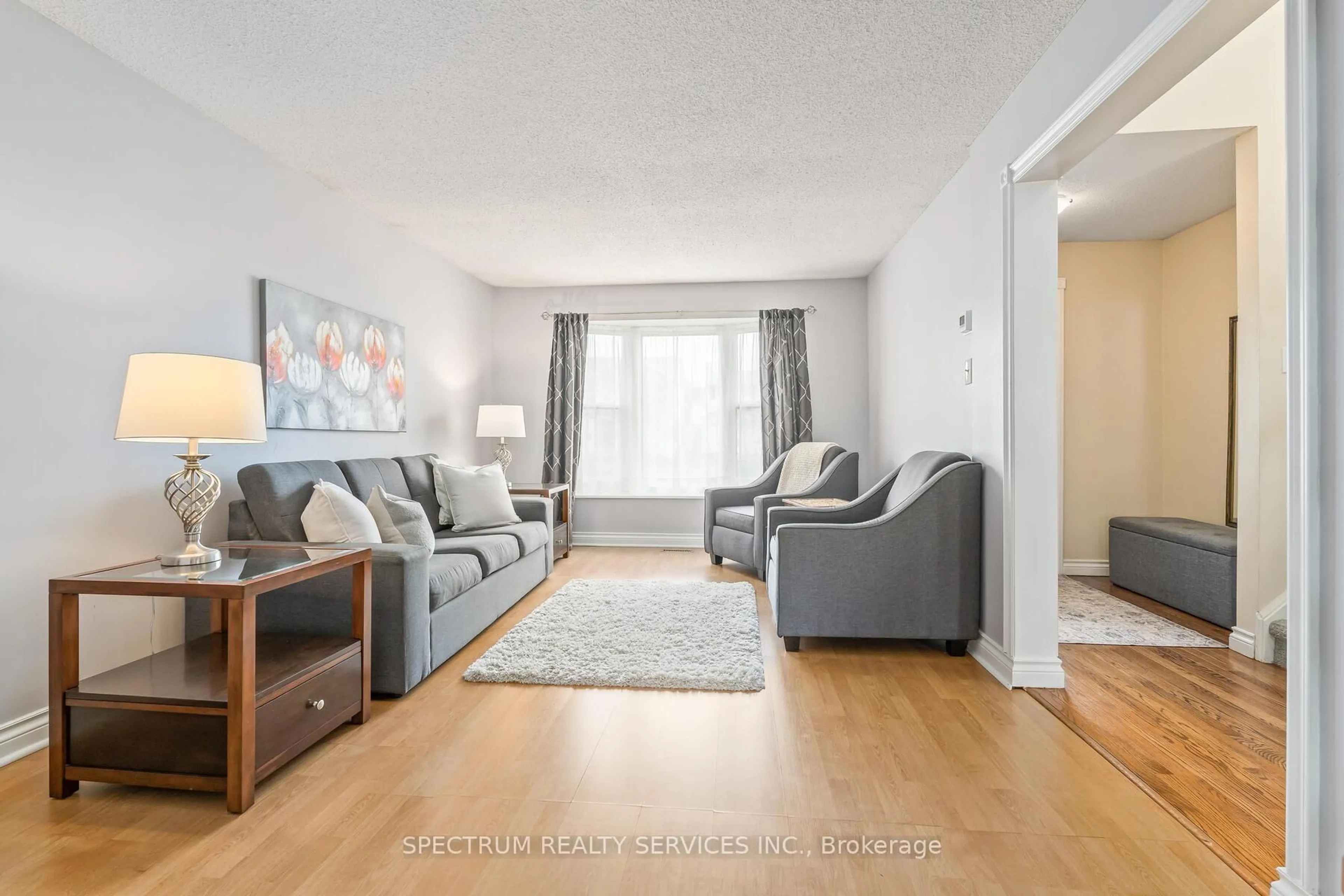 Living room with furniture, wood/laminate floor for 98 Mikado Cres, Brampton Ontario L6S 3R7