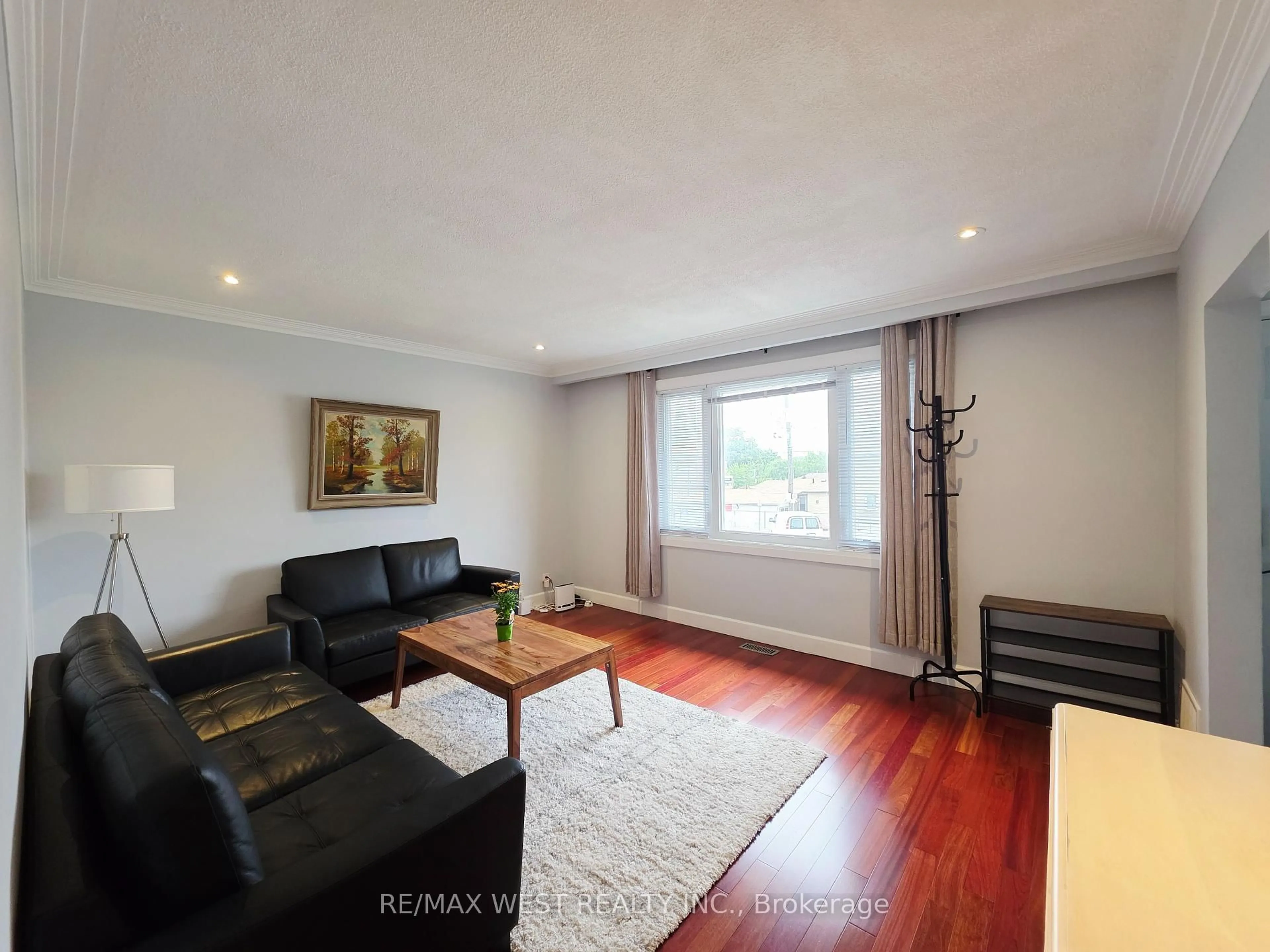 Living room with furniture, wood/laminate floor for 357 Rustic Rd, Toronto Ontario M6L 1W6
