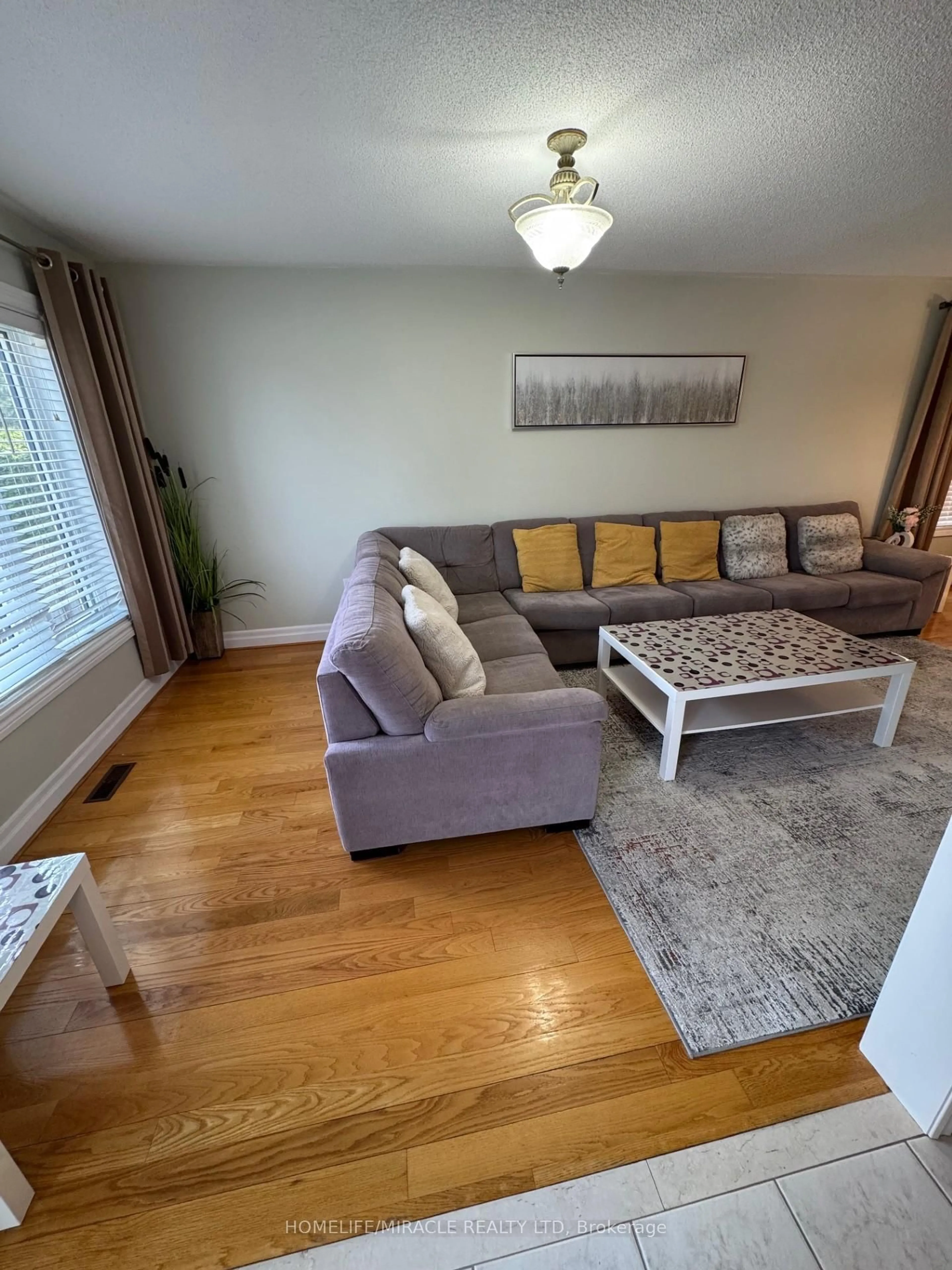 Living room with furniture, wood/laminate floor for 608 Driftcurrent Dr, Mississauga Ontario L4Z 4A4