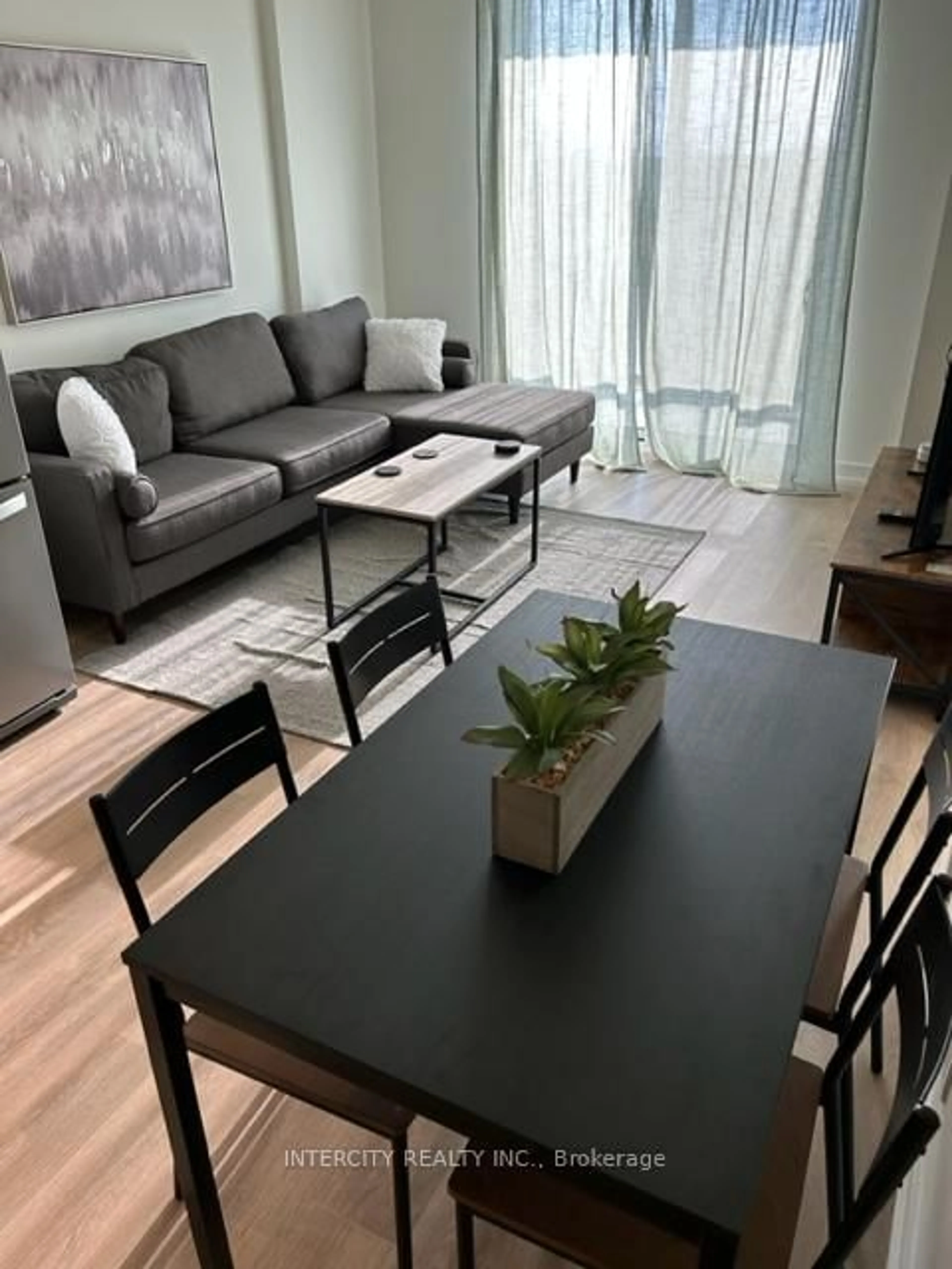 Living room with furniture, wood/laminate floor for 345 Wheat Boom Dr #505, Oakville Ontario L6H 7X4
