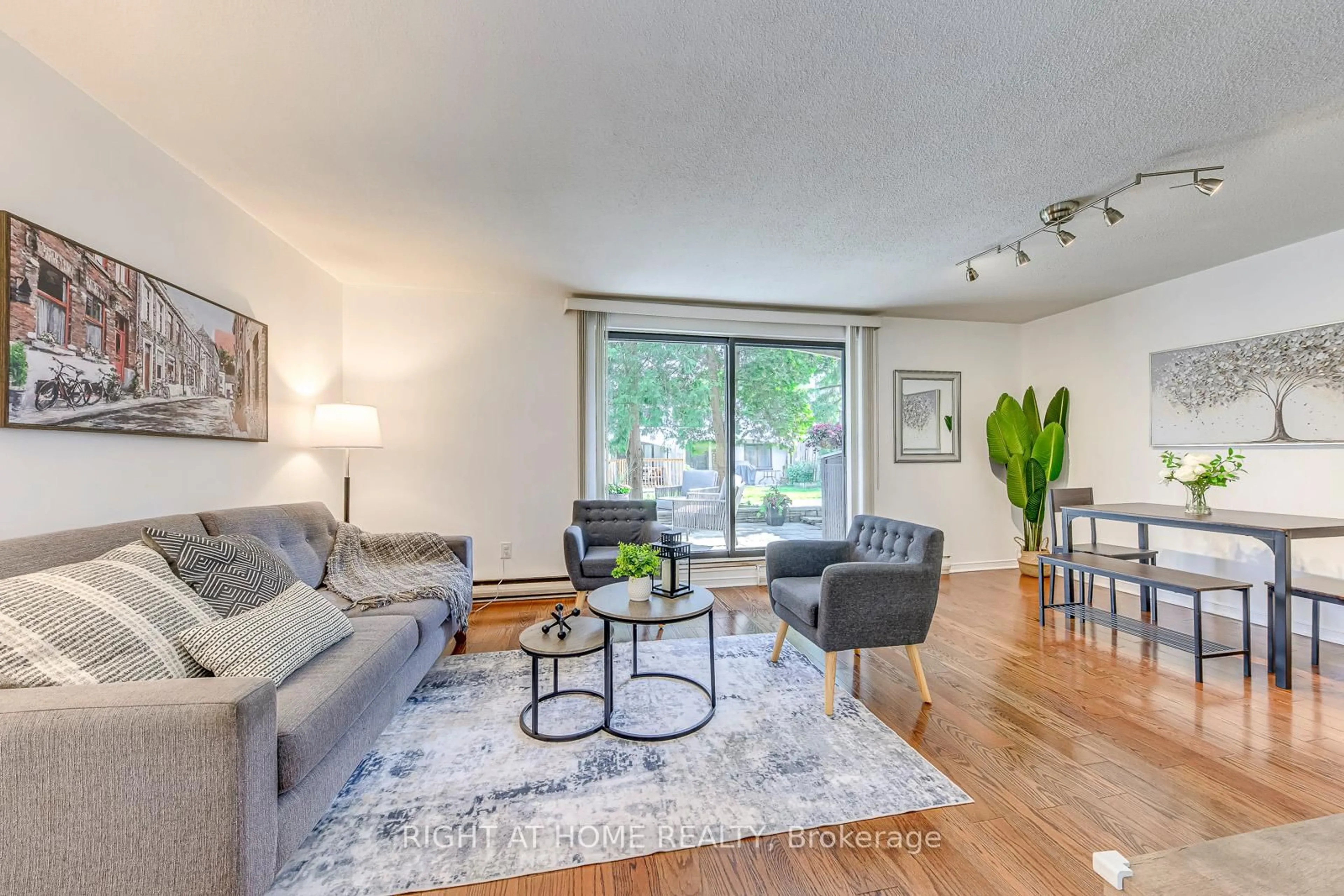 Living room with furniture, wood/laminate floor for 1058 Falgarwood Dr #133, Oakville Ontario L6H 2P3