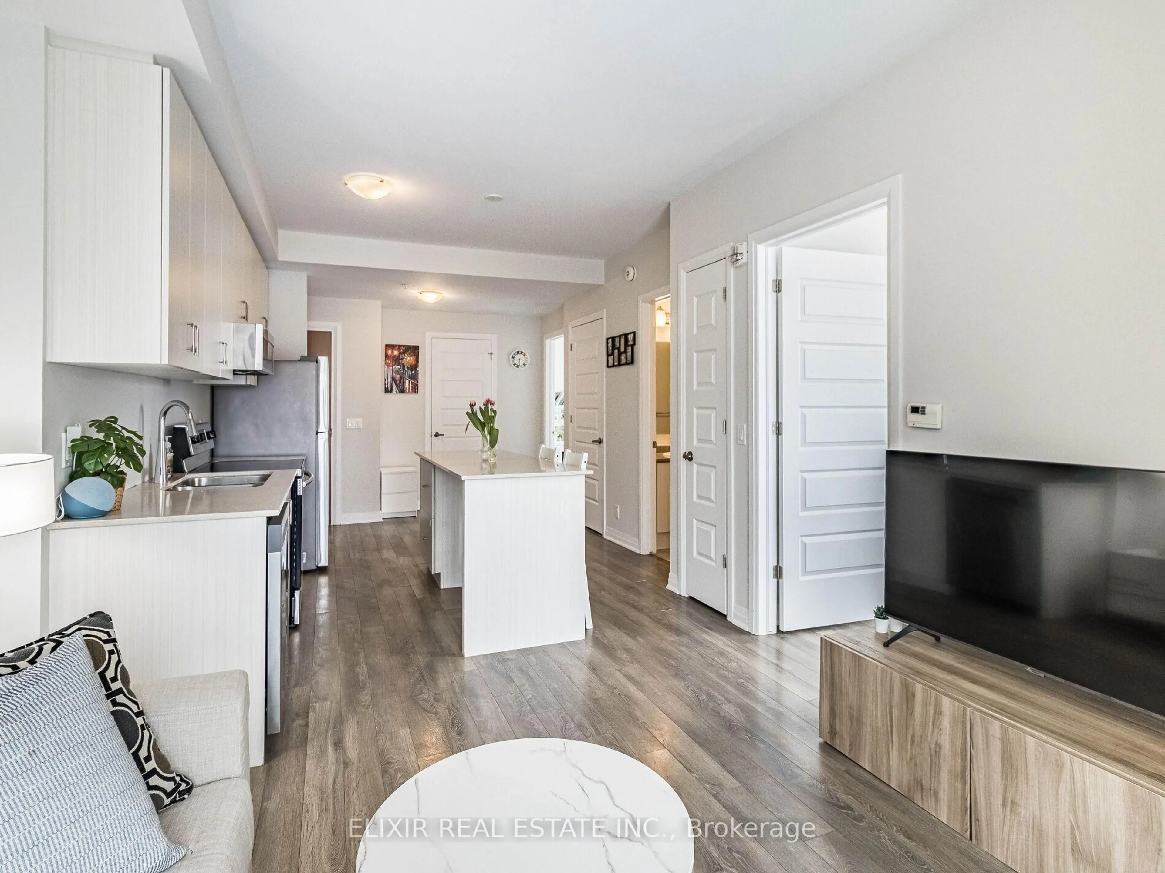 Open concept kitchen, wood/laminate floor for 1105 Leger Way #129, Milton Ontario L9E 1K7