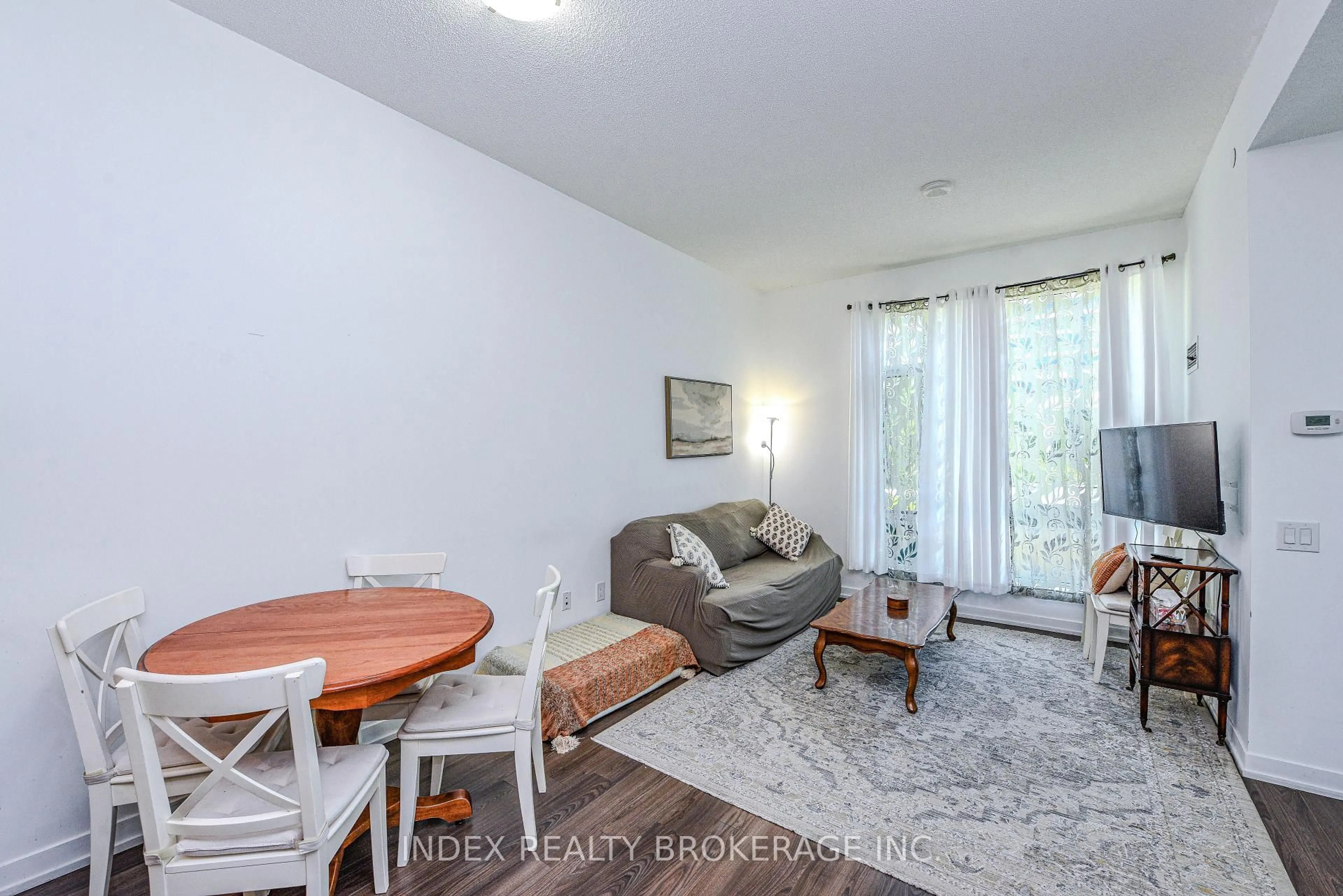 Living room with furniture, wood/laminate floor for 2560 Eglington Ave #103, Mississauga Ontario L5M 0Y3