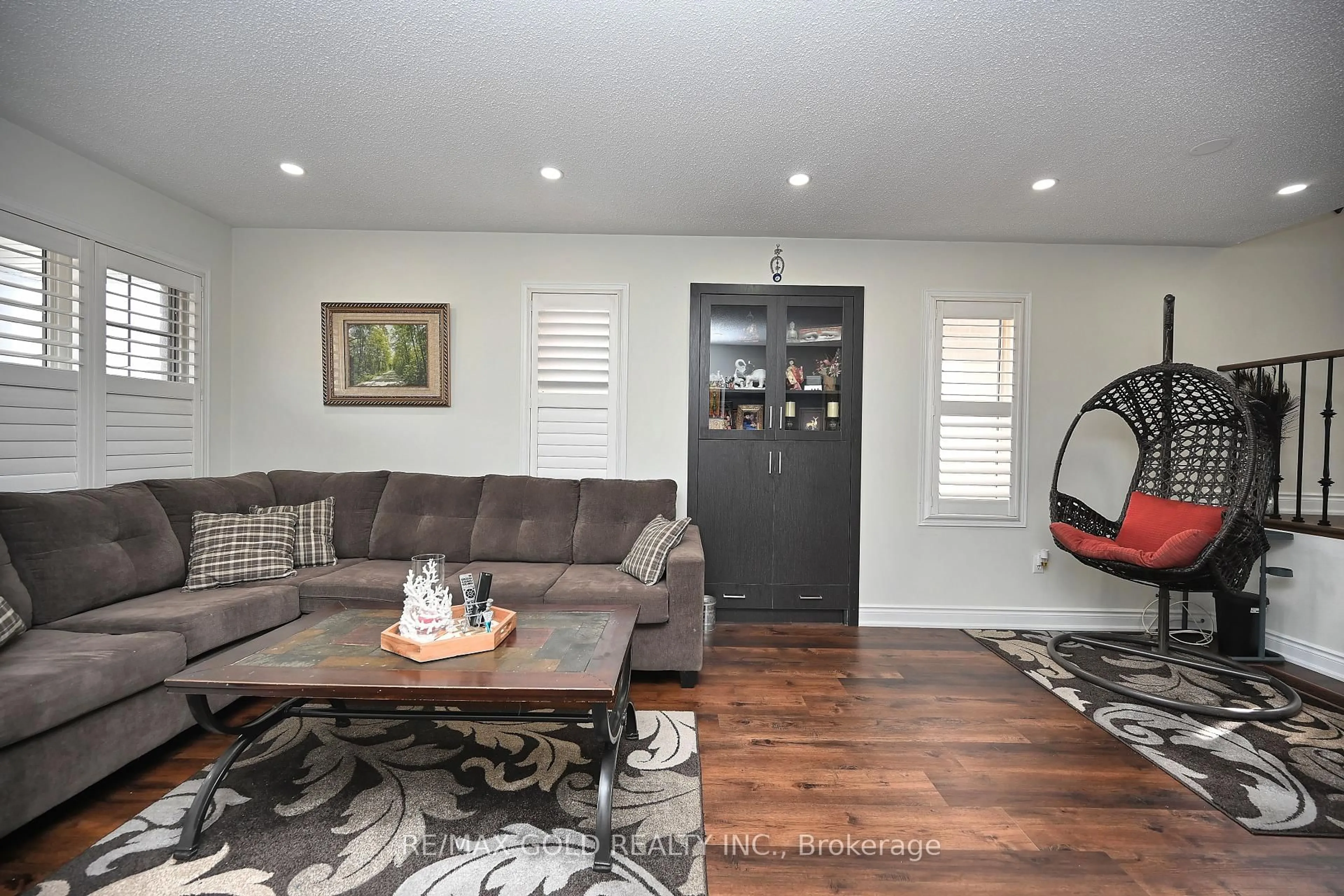 Living room with furniture, wood/laminate floor for 34 Saintsbury Cres, Brampton Ontario L6R 2W3