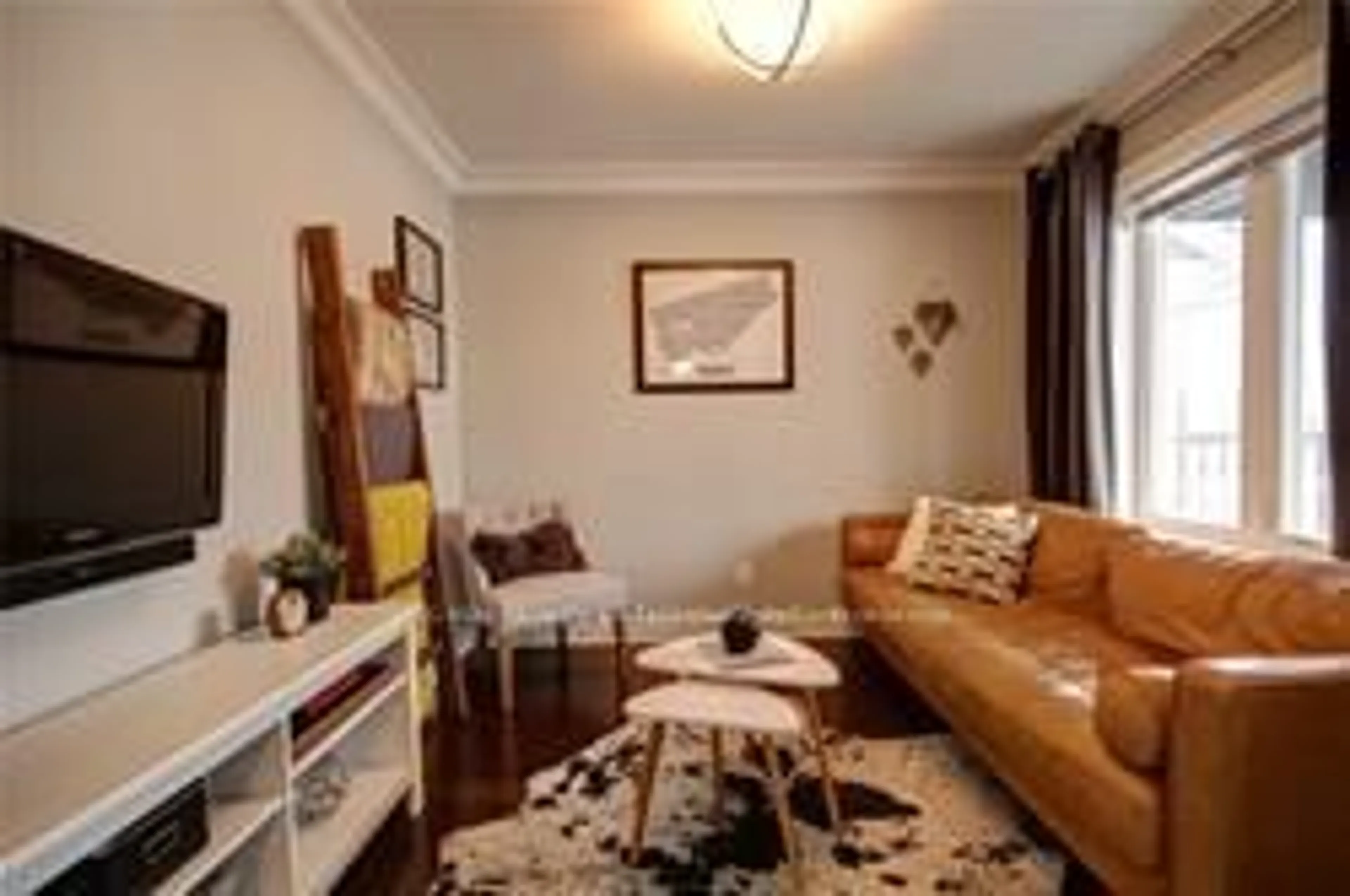 Living room with furniture, wood/laminate floor for 96 Manitoba St, Toronto Ontario M8Y 1C9
