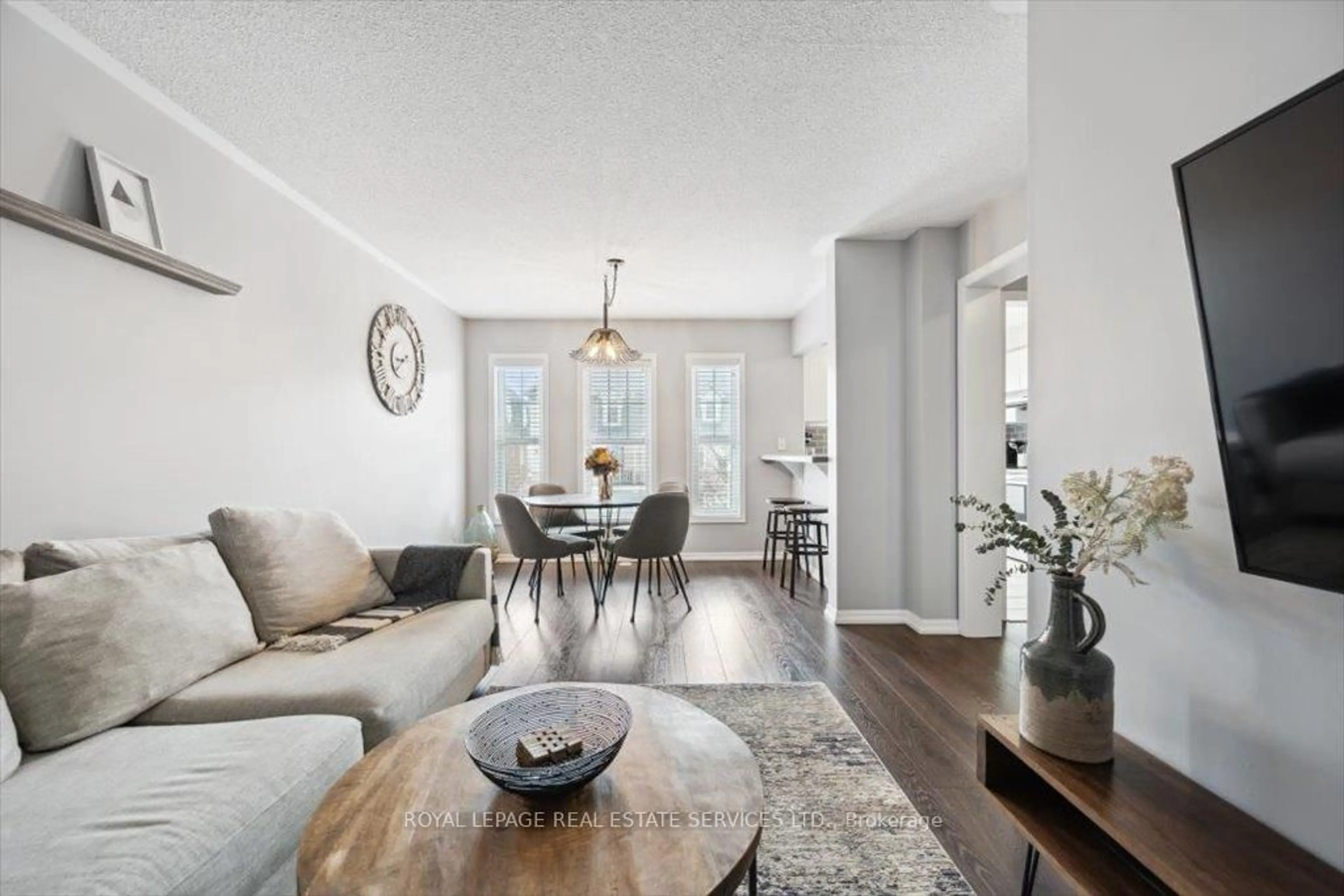 Living room with furniture, wood/laminate floor for 922 Brassard Circ, Milton Ontario L9T 8E3