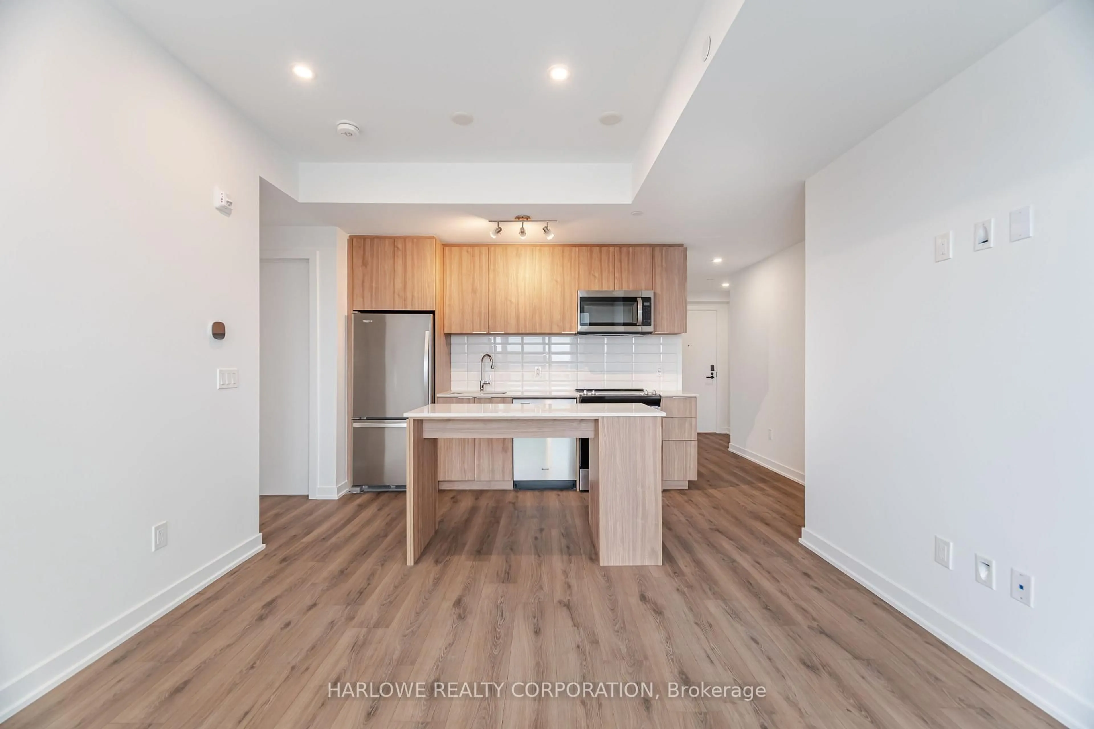 Open concept kitchen, wood/laminate floor for 770 Whitlock Ave #306, Milton Ontario L9E 1S2