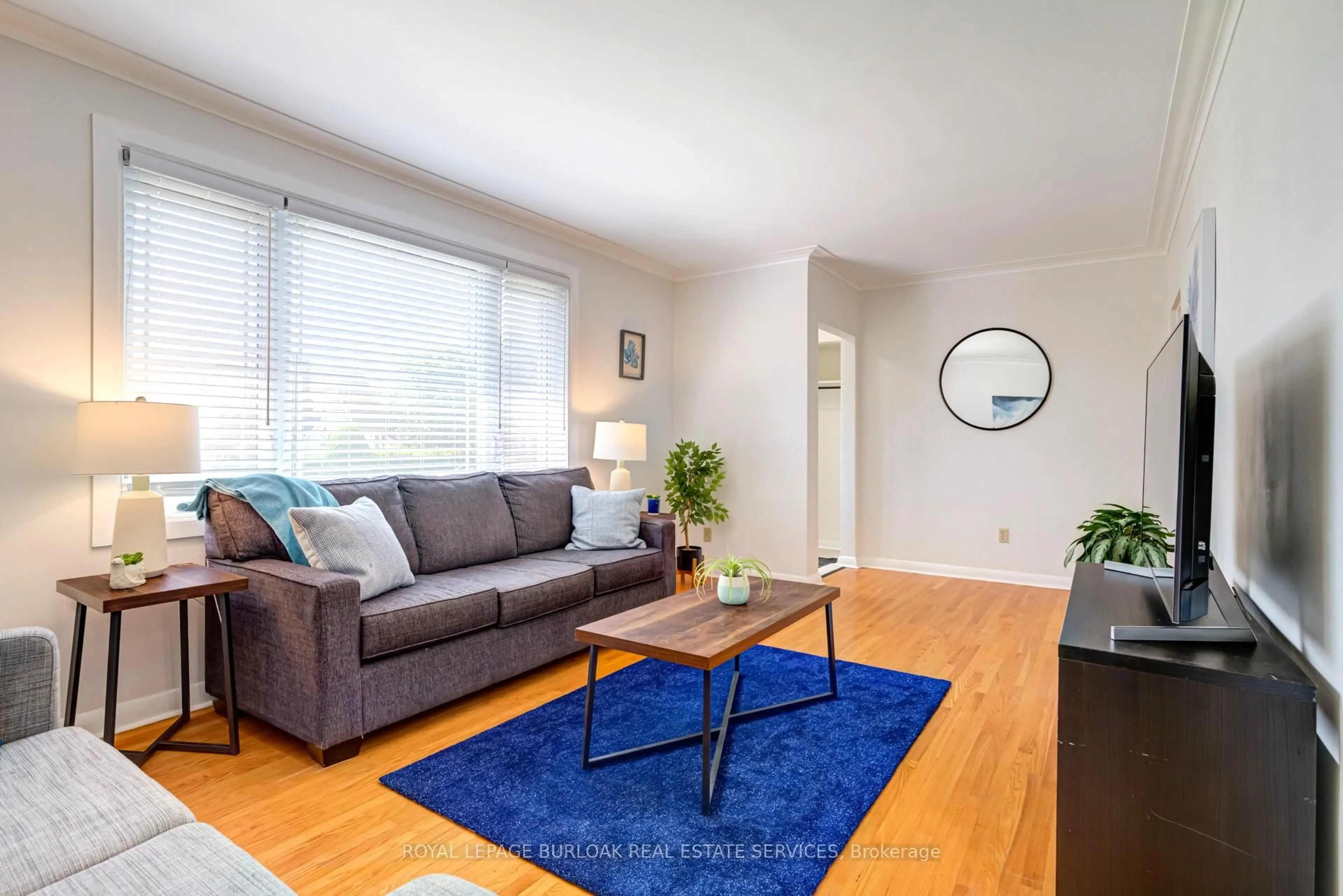 Living room with furniture, wood/laminate floor for 671 Wickens Ave, Burlington Ontario L7T 3T1