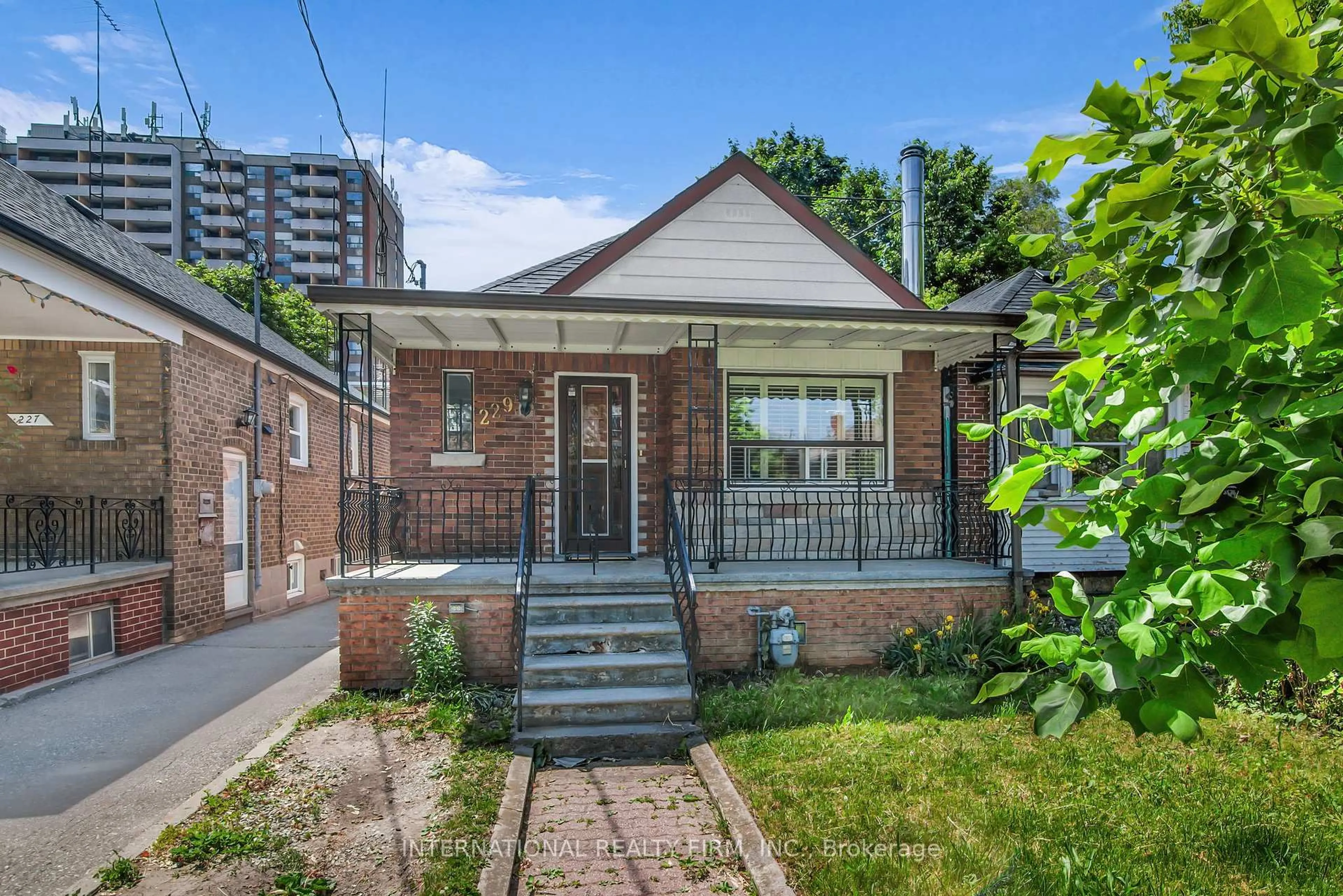 Home with brick exterior material, street for 229 Livingstone Ave, Toronto Ontario M6E 2M3