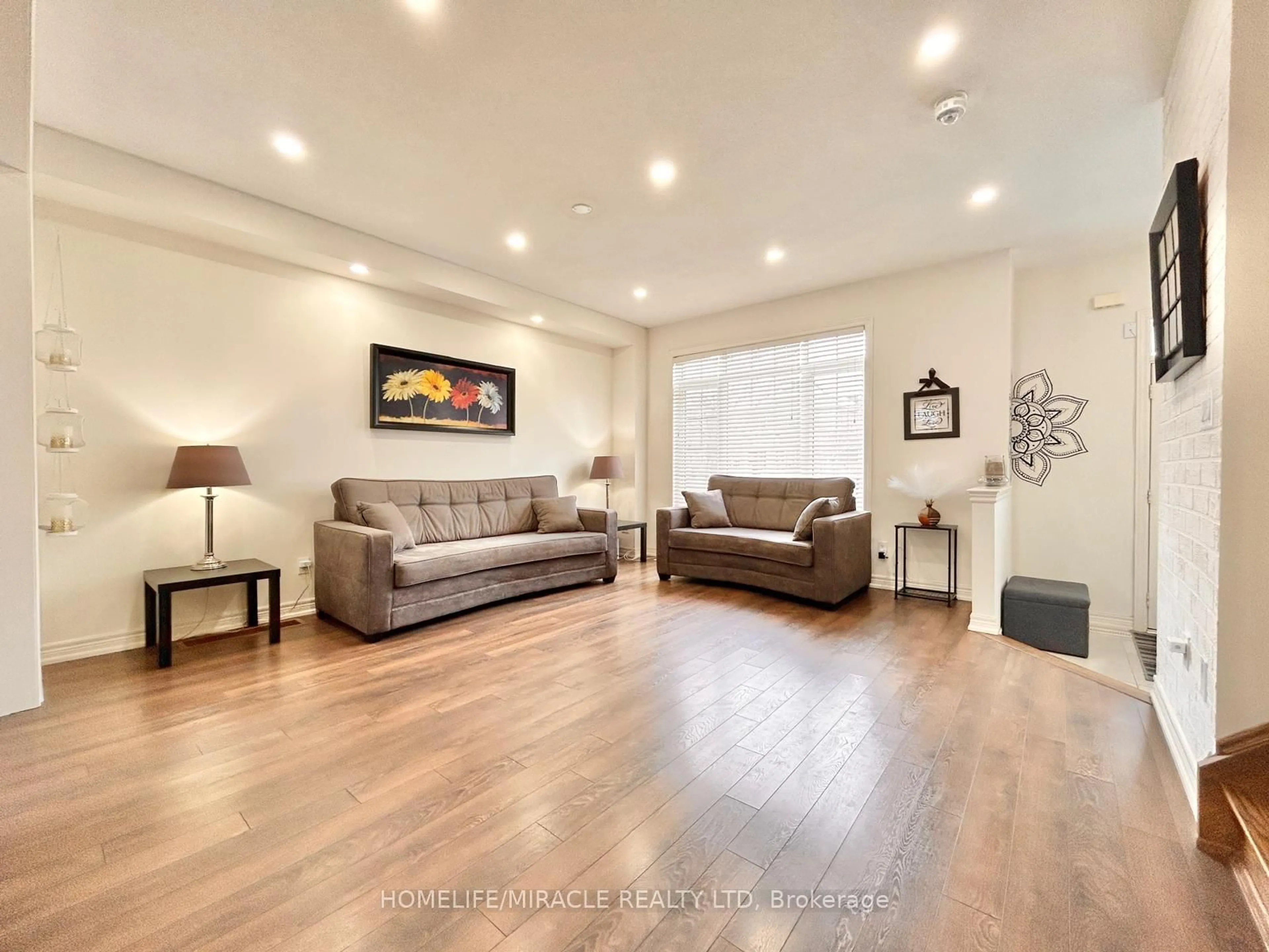 Living room with furniture, wood/laminate floor for 149 Remembrance Rd, Brampton Ontario L7A 3Y2