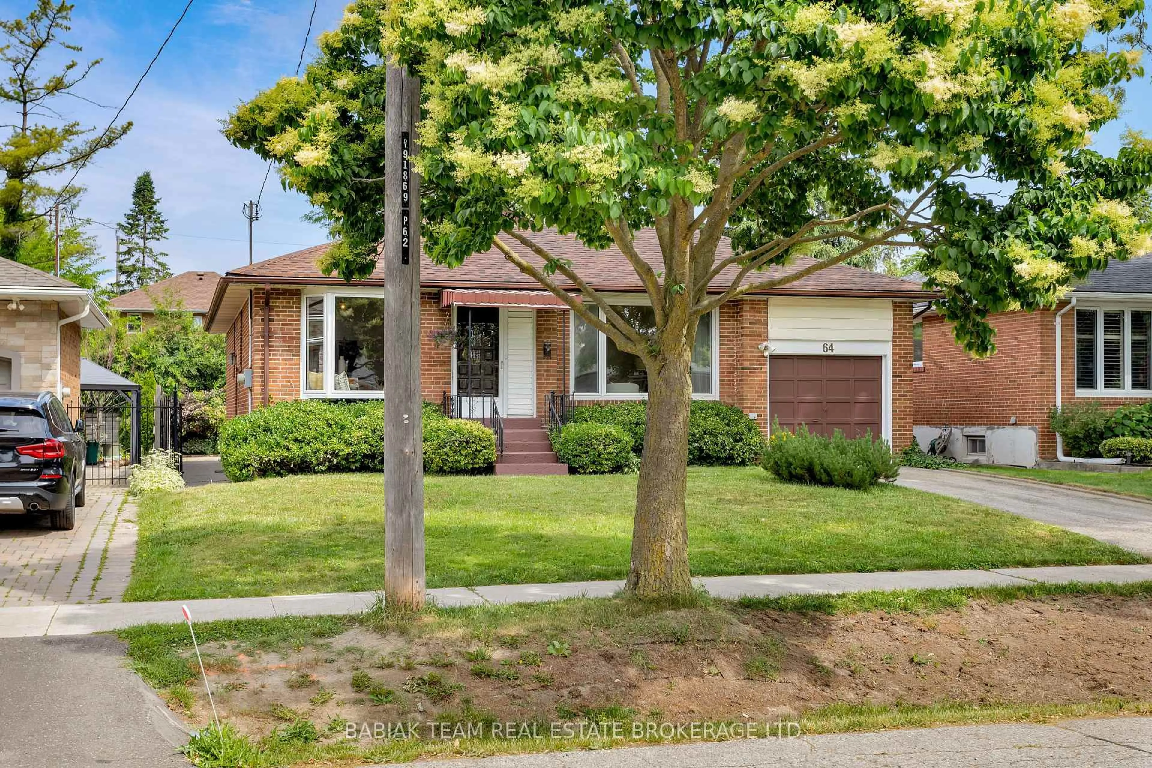 Home with brick exterior material, street for 64 Mooreshead Dr, Toronto Ontario M9C 2S3
