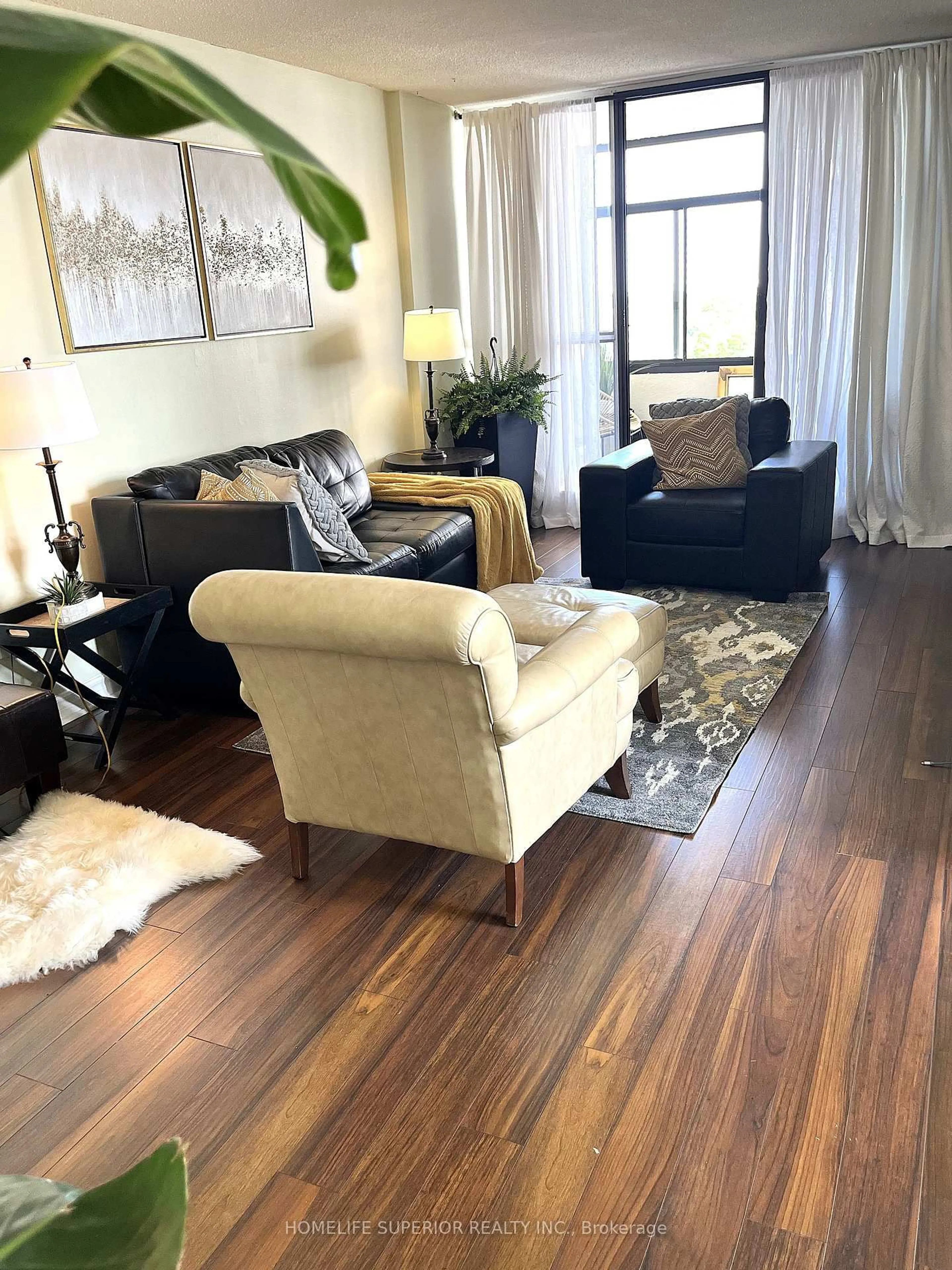 Living room with furniture, wood/laminate floor for 25 Kensington Rd #1011, Brampton Ontario L6T 3W8
