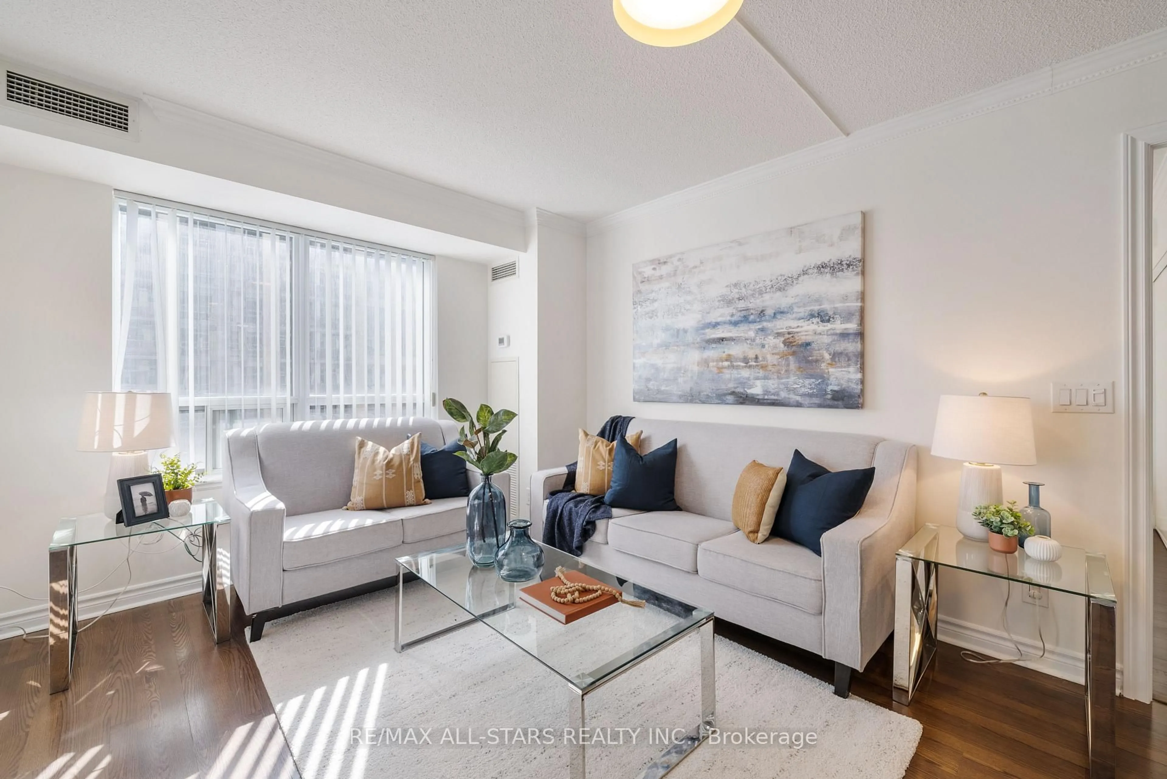 Living room with furniture, wood/laminate floor for 5 Michael Power Pl #1003, Toronto Ontario M9A 0A3