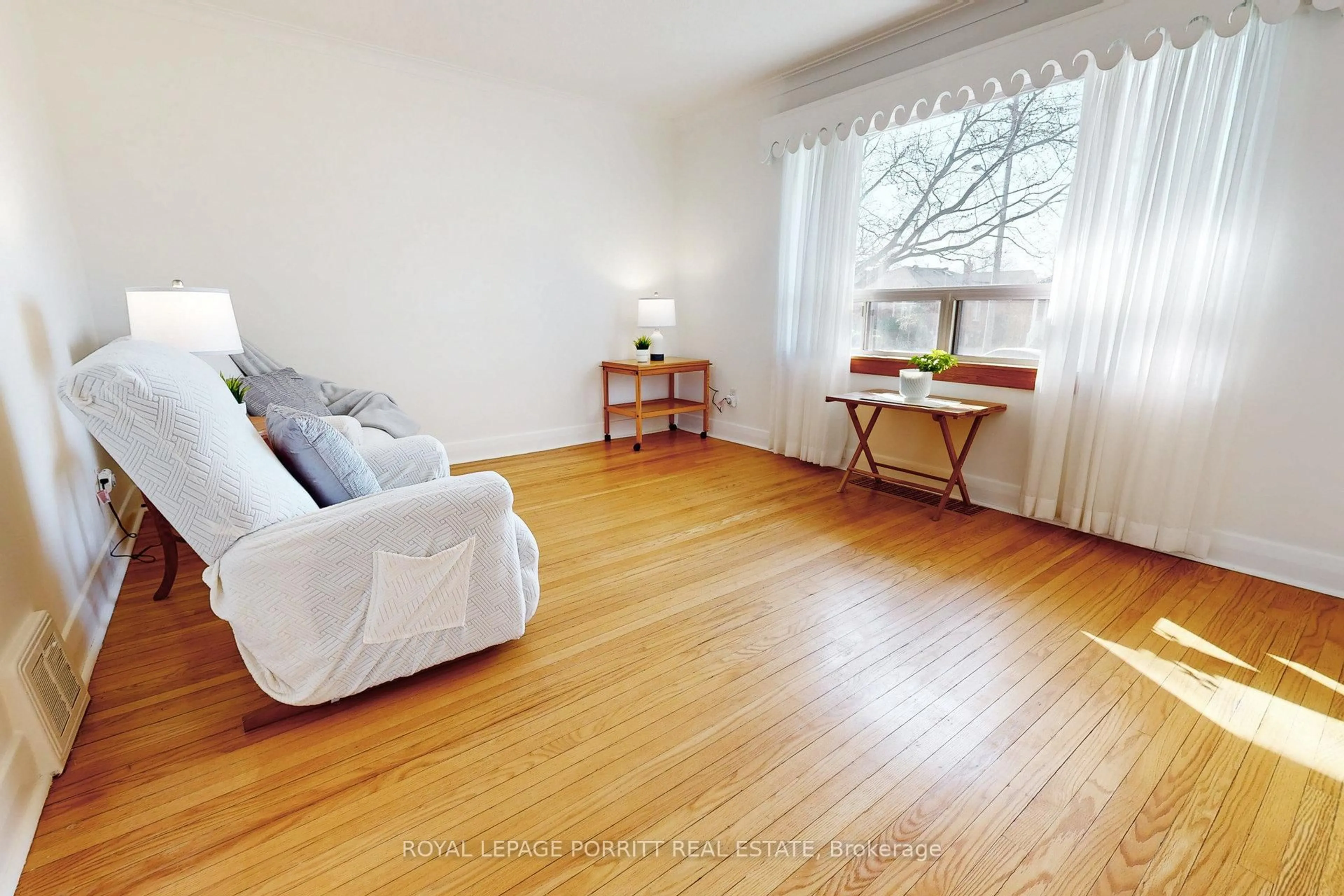Living room with furniture, wood/laminate floor for 284 Lanor Ave, Toronto Ontario M8W 2P9