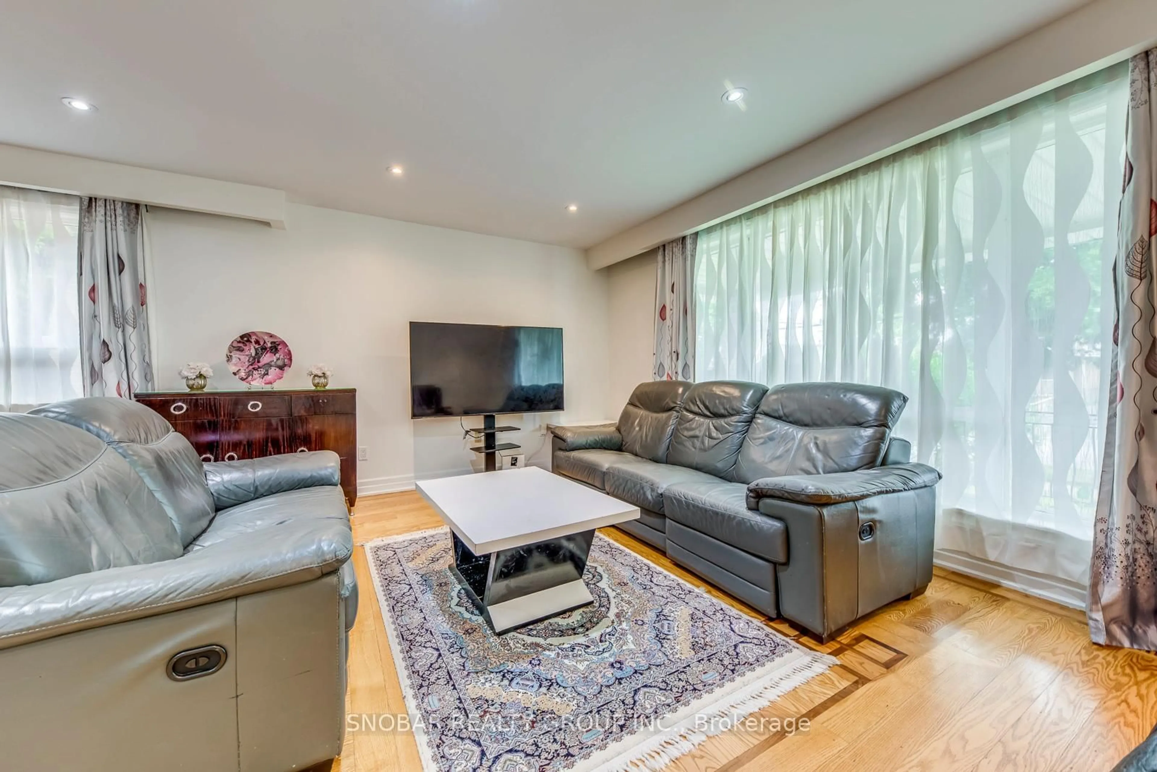 Living room with furniture, wood/laminate floor for 34 Barkwin Dr, Toronto Ontario M9V 2W3