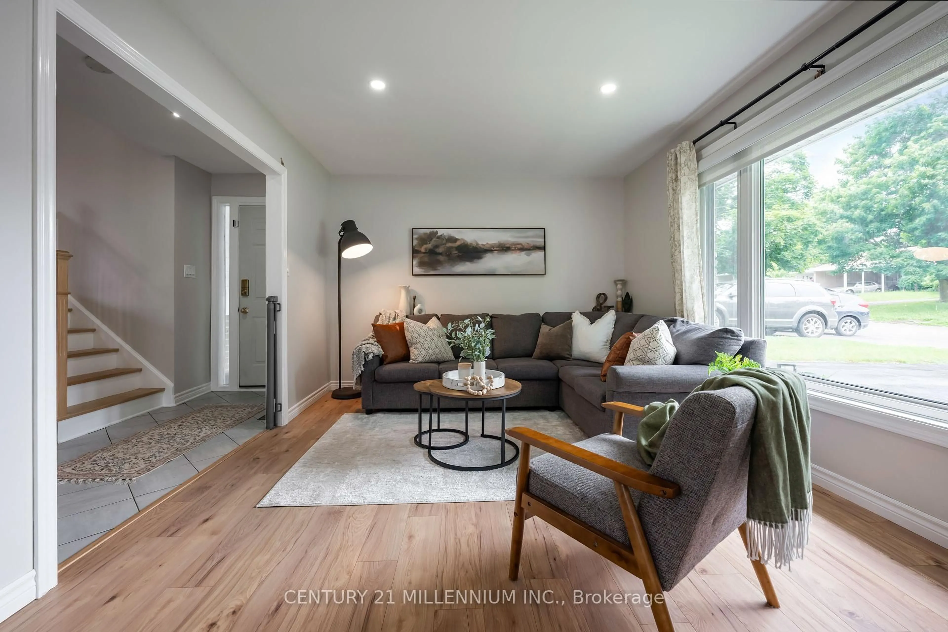 Living room with furniture, wood/laminate floor for 33 Caledonia Rd, Orangeville Ontario L9W 2V2