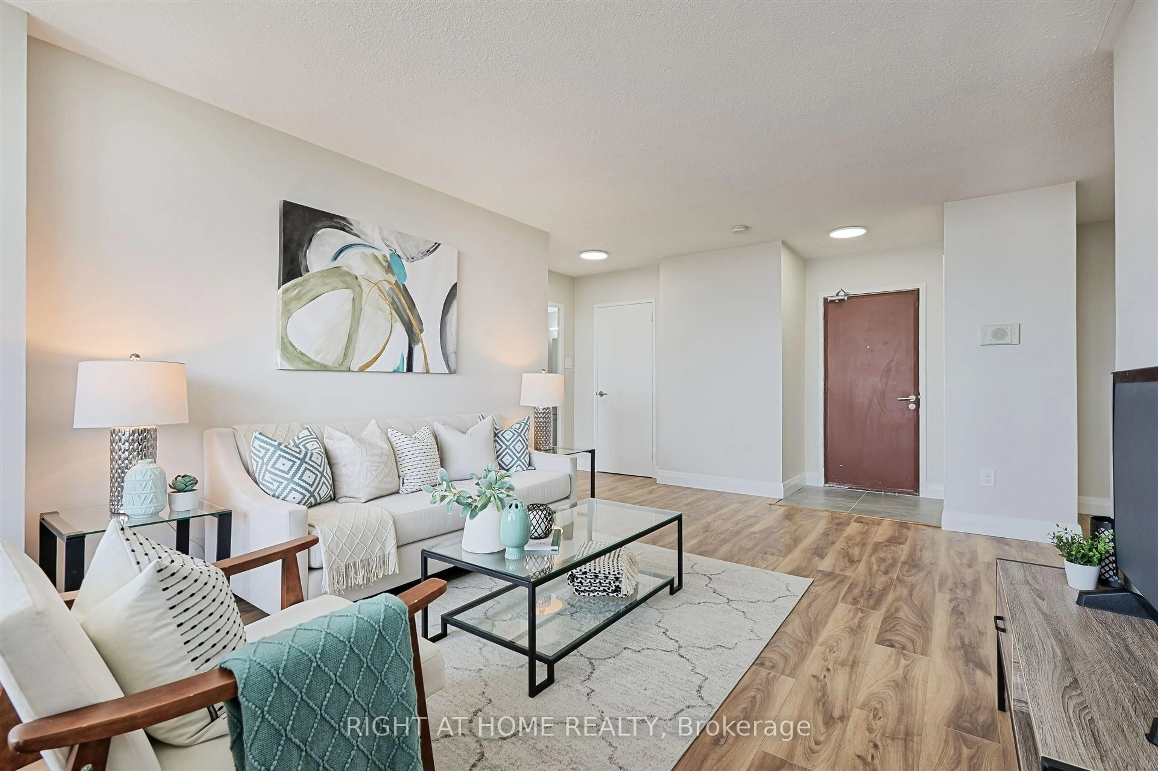 Living room with furniture, wood/laminate floor for 235 Grandravine Dr #812, Toronto Ontario M3N 1J2