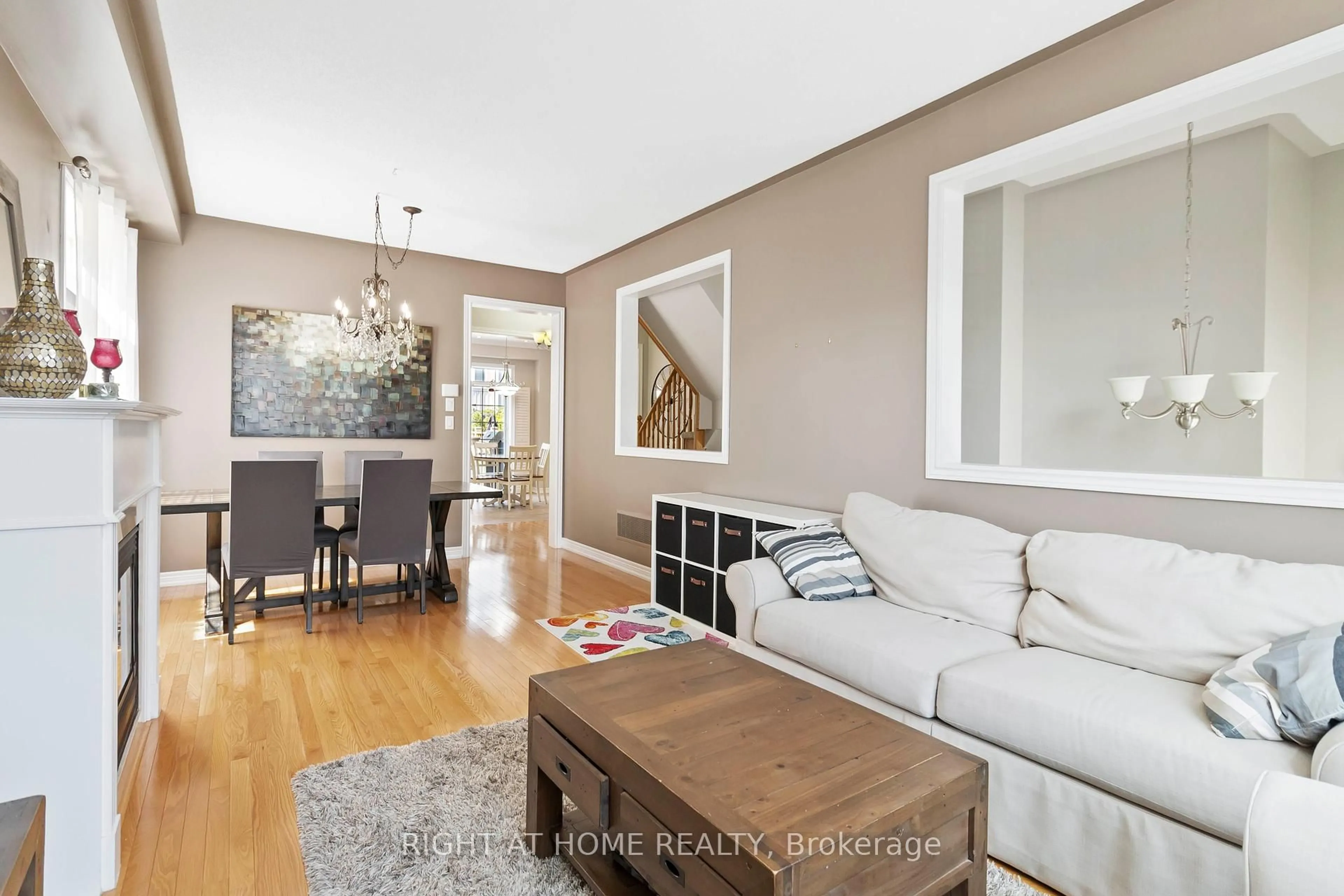 Living room with furniture, wood/laminate floor for 43 Sutcliff Lane, Halton Hills Ontario L7G 0C2