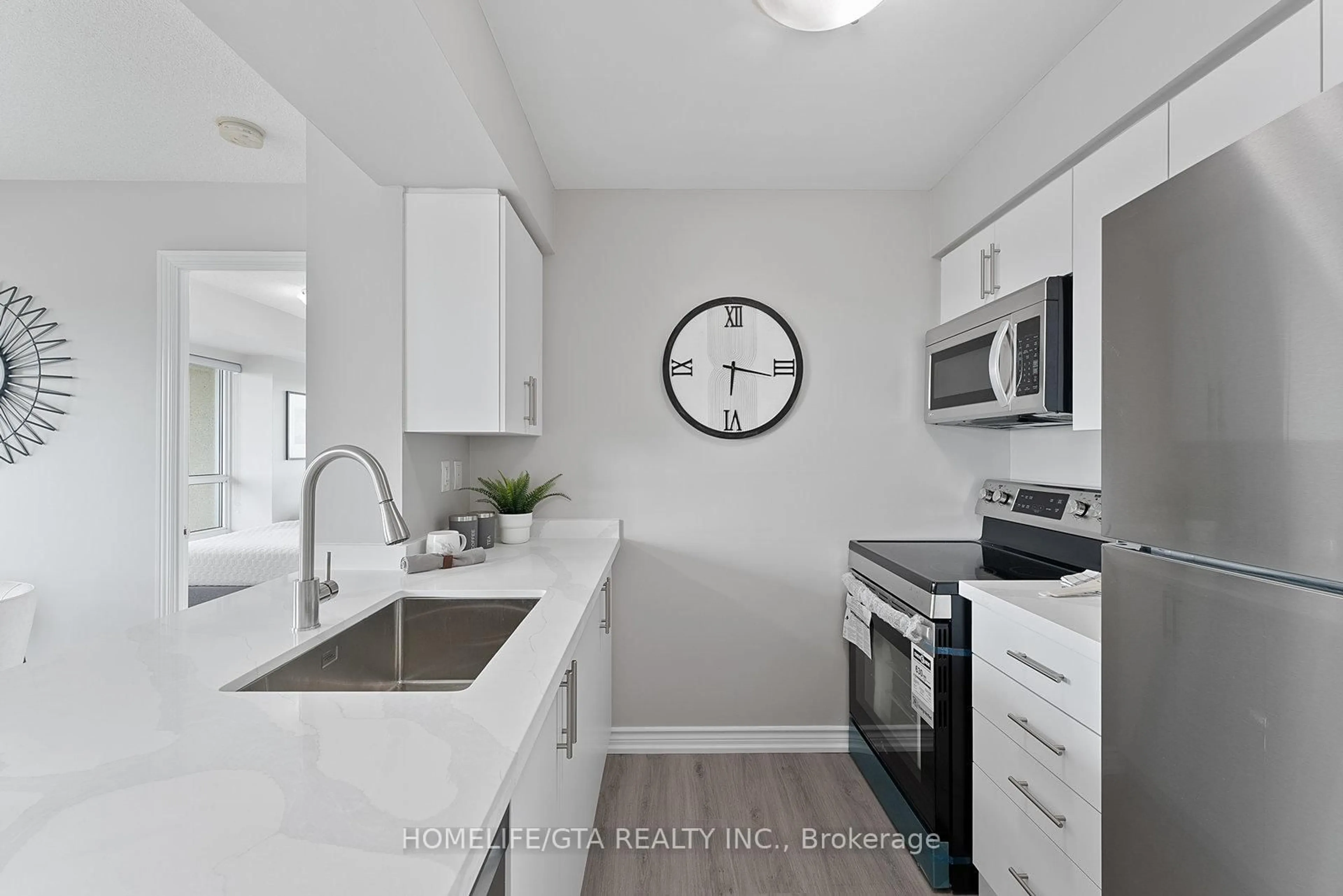 Kitchen with laundary machines, ceramic/tile floor for 215 Queen St #1803, Brampton Ontario L6W 0A9
