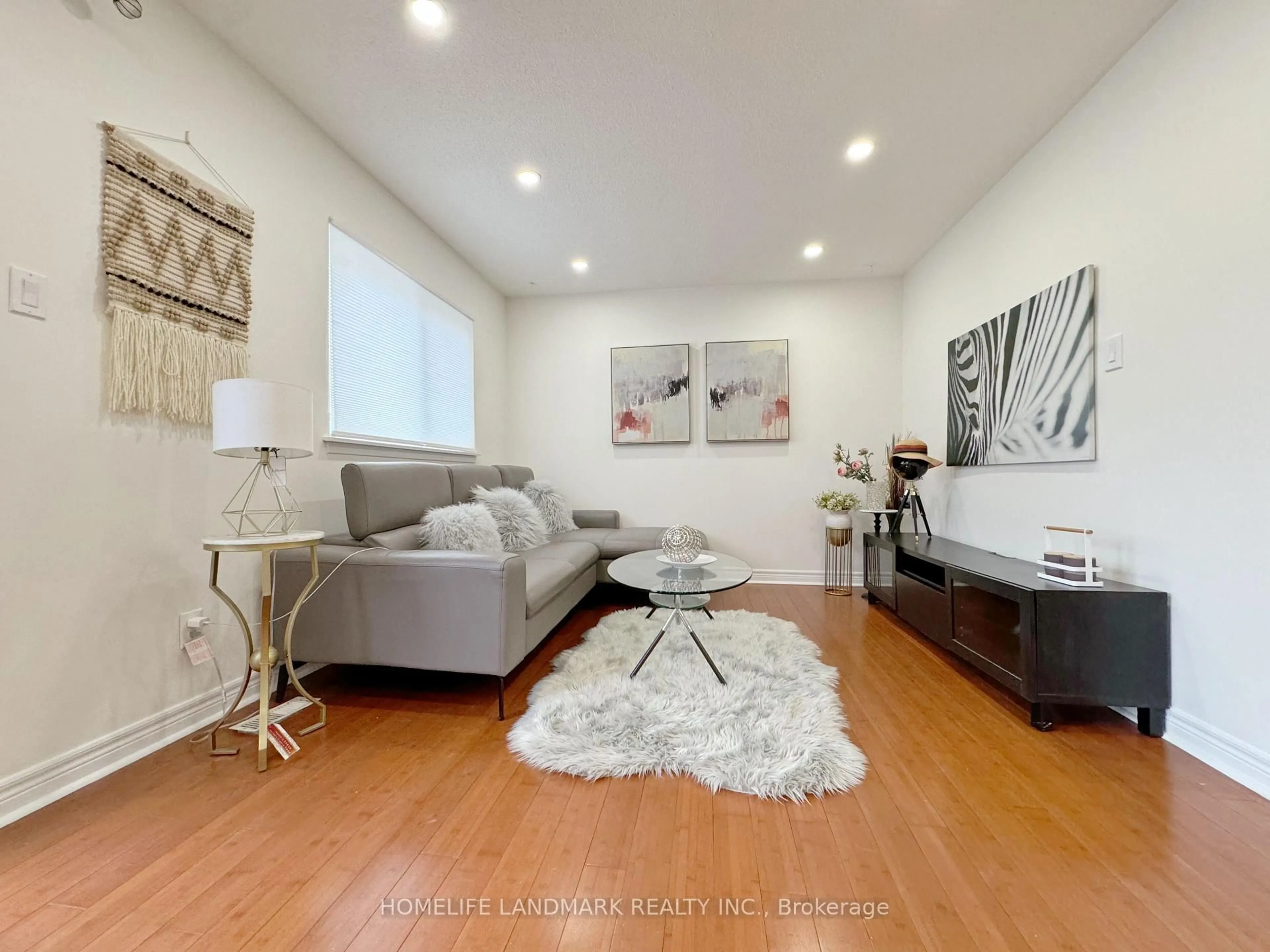 Living room with furniture, wood/laminate floor for 900 Central Park Dr #1, Brampton Ontario L6S 3J6