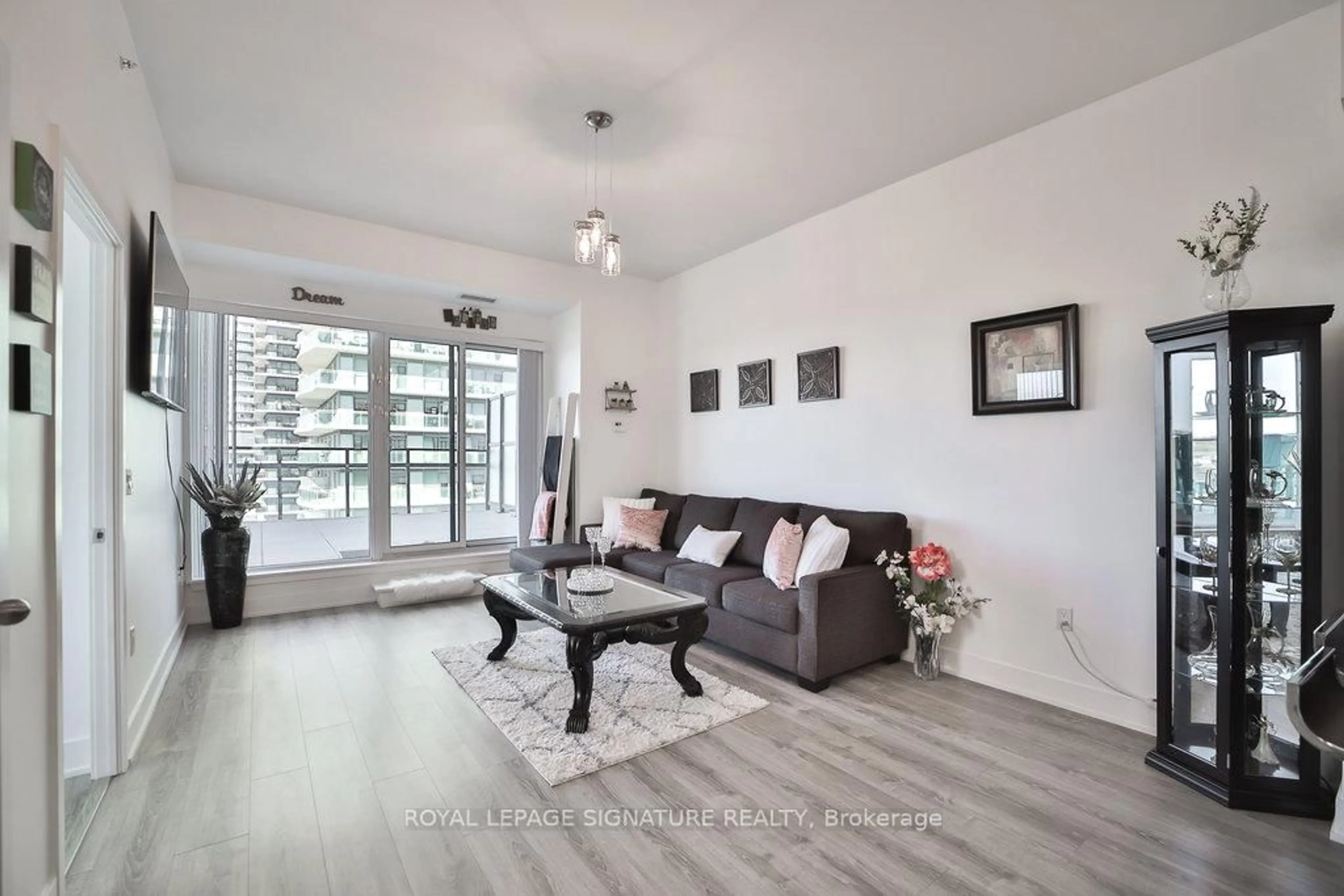 Living room with furniture, wood/laminate floor for 30 Shore Breeze Dr #913, Toronto Ontario M8V 0J1