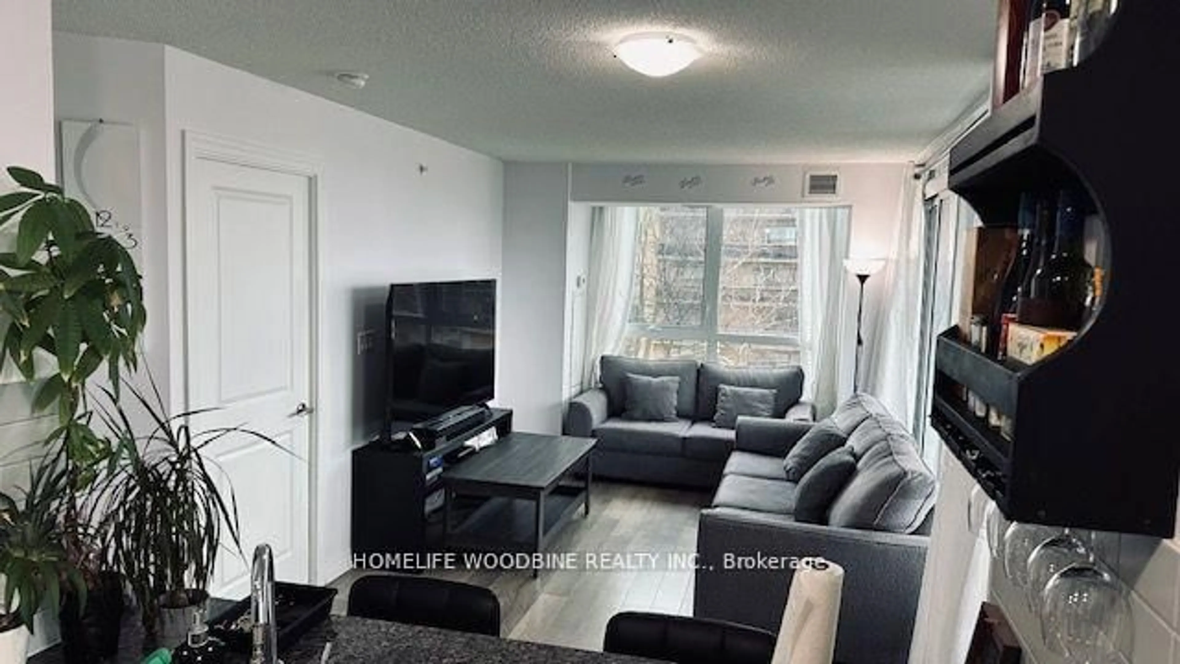 Living room with furniture, wood/laminate floor for 80 Esther Lorrie Dr #312, Toronto Ontario M9W 0C6