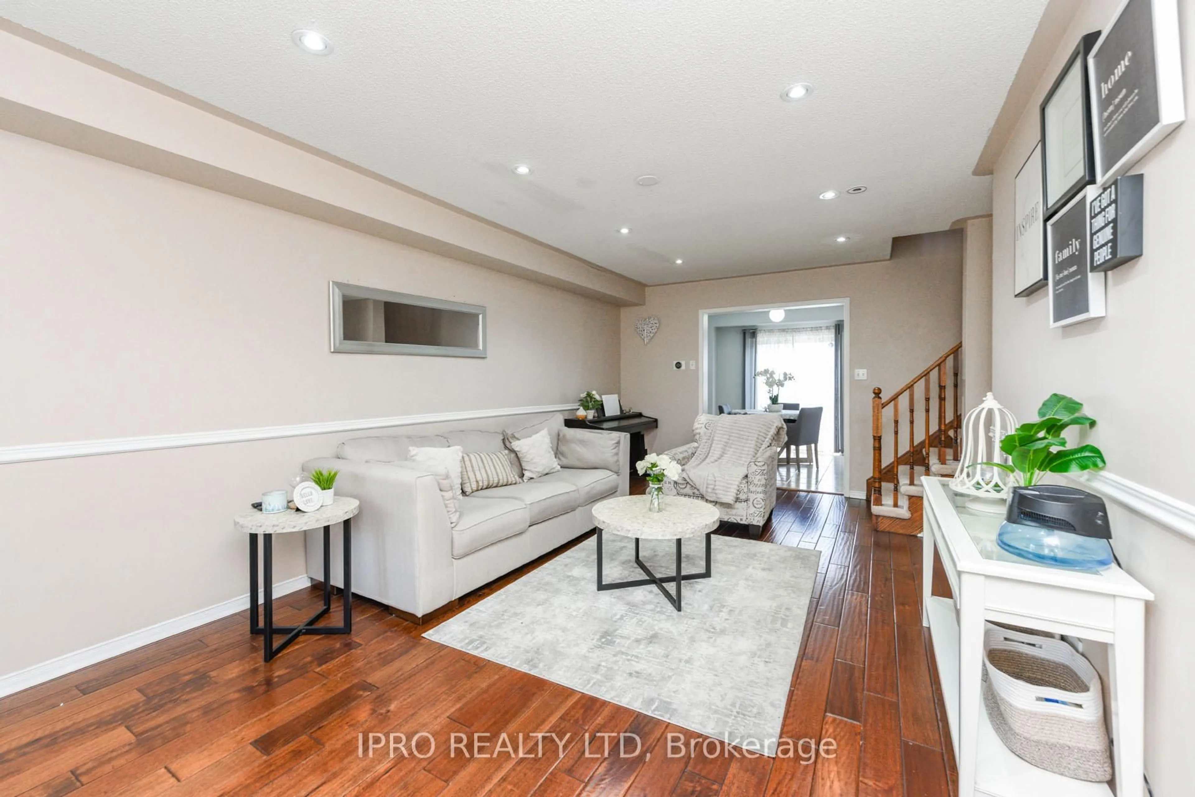Living room with furniture, wood/laminate floor for 12 Bramcedar Cres, Brampton Ontario L7A 1T1