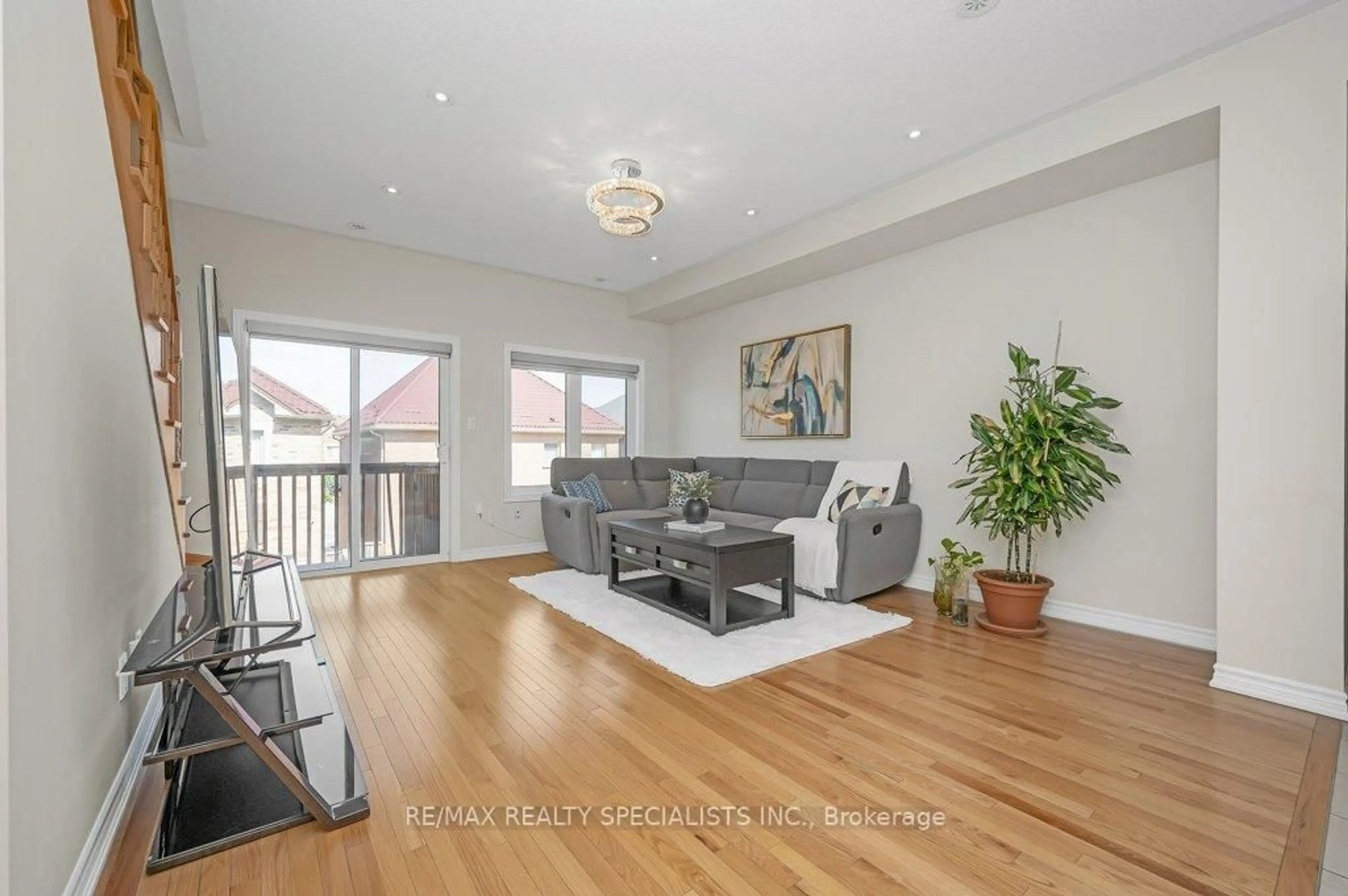 Living room with furniture, wood/laminate floor for 34 Aspen Hills Rd, Brampton Ontario L6Y 6E4