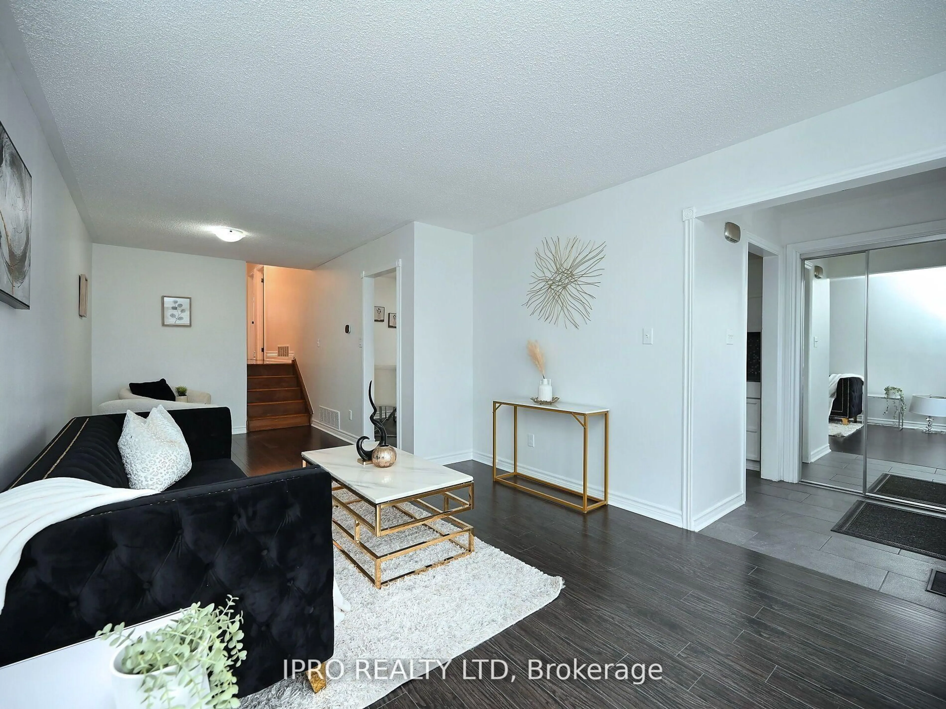 Living room with furniture, wood/laminate floor for 7646 Priory Cres, Mississauga Ontario L4T 3H5