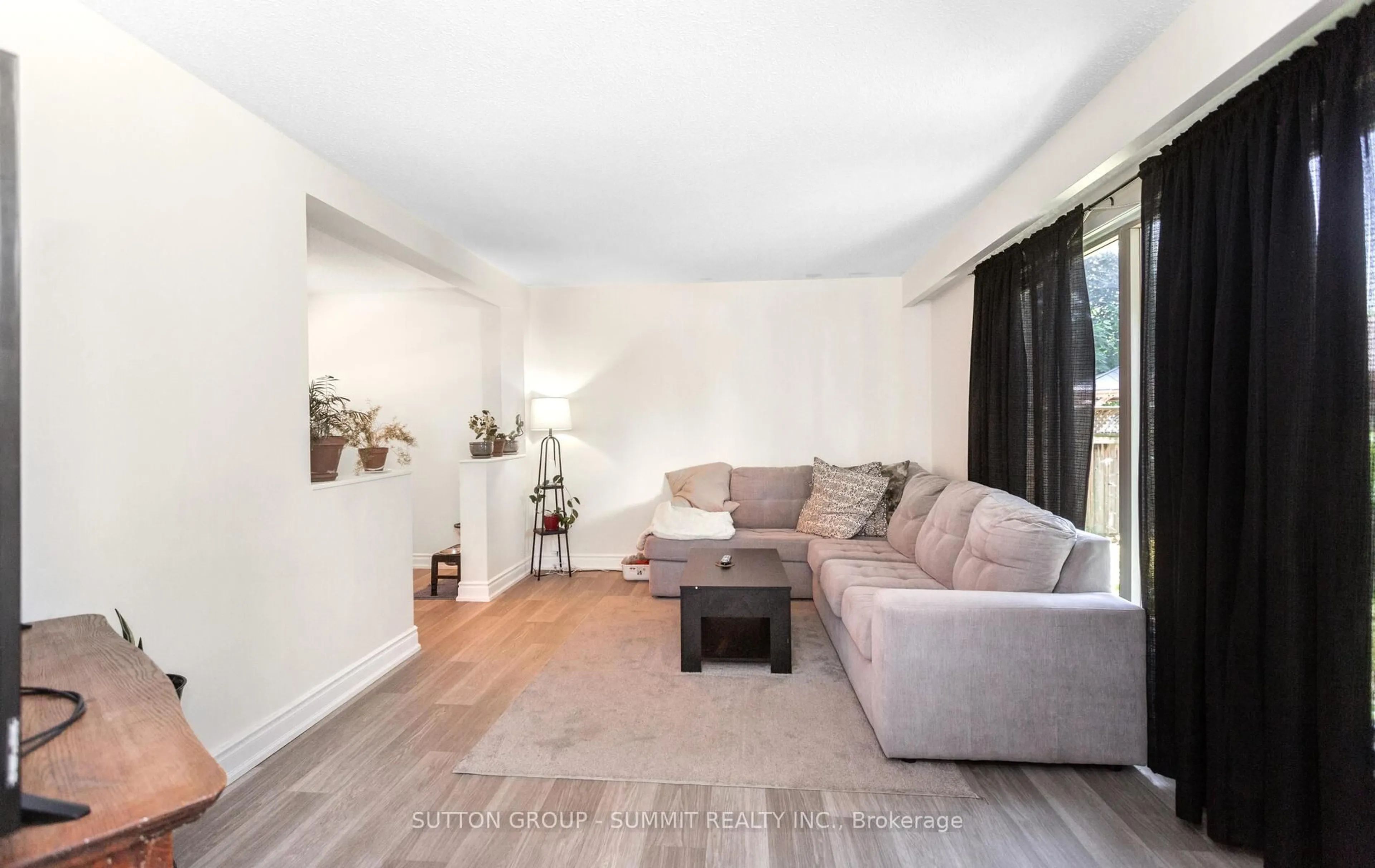 Living room with furniture, wood/laminate floor for 28 Storey Dr, Halton Hills Ontario L7J 2S9