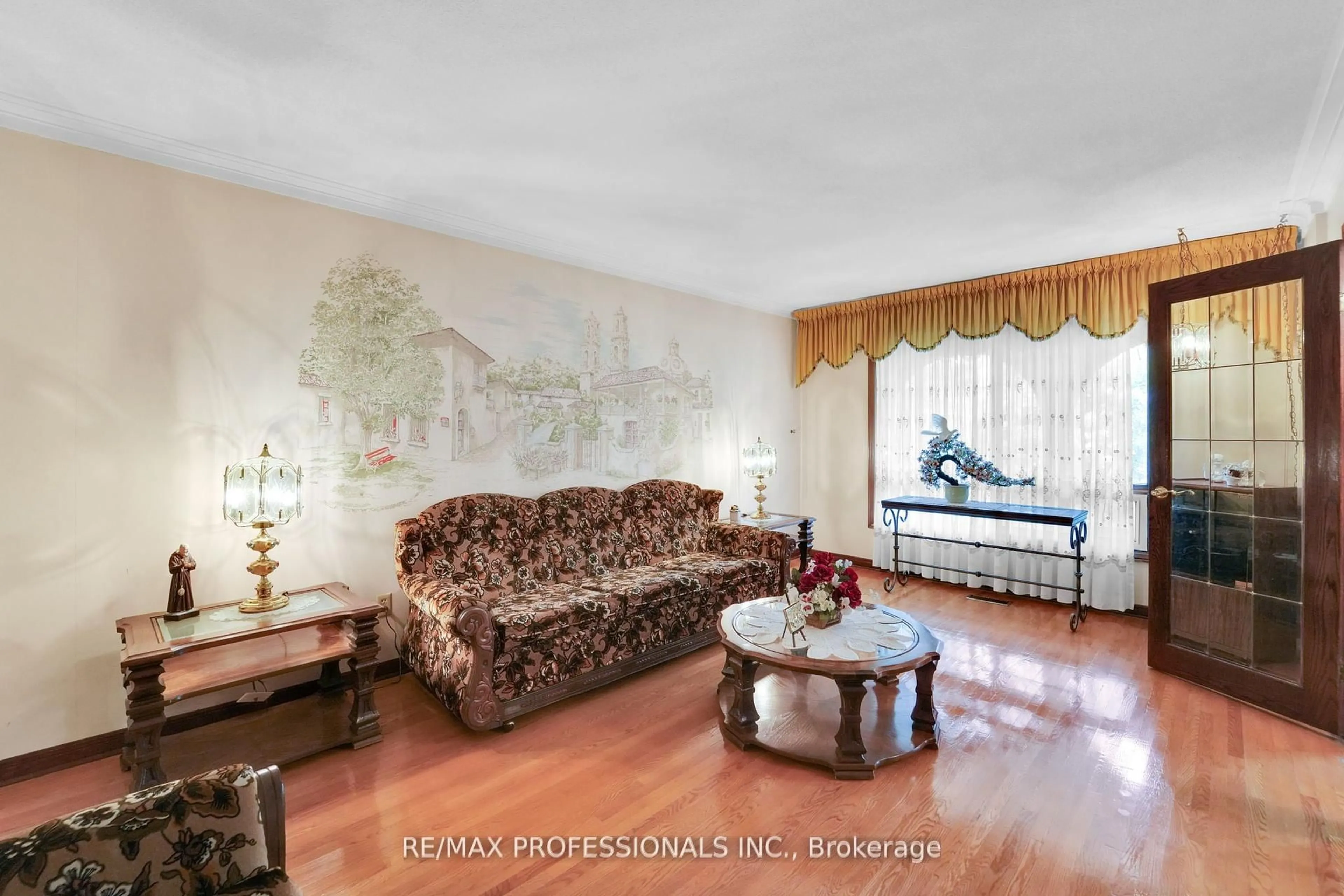 Living room with furniture, wood/laminate floor for 65 Strathburn Blvd, Toronto Ontario M9M 2X8