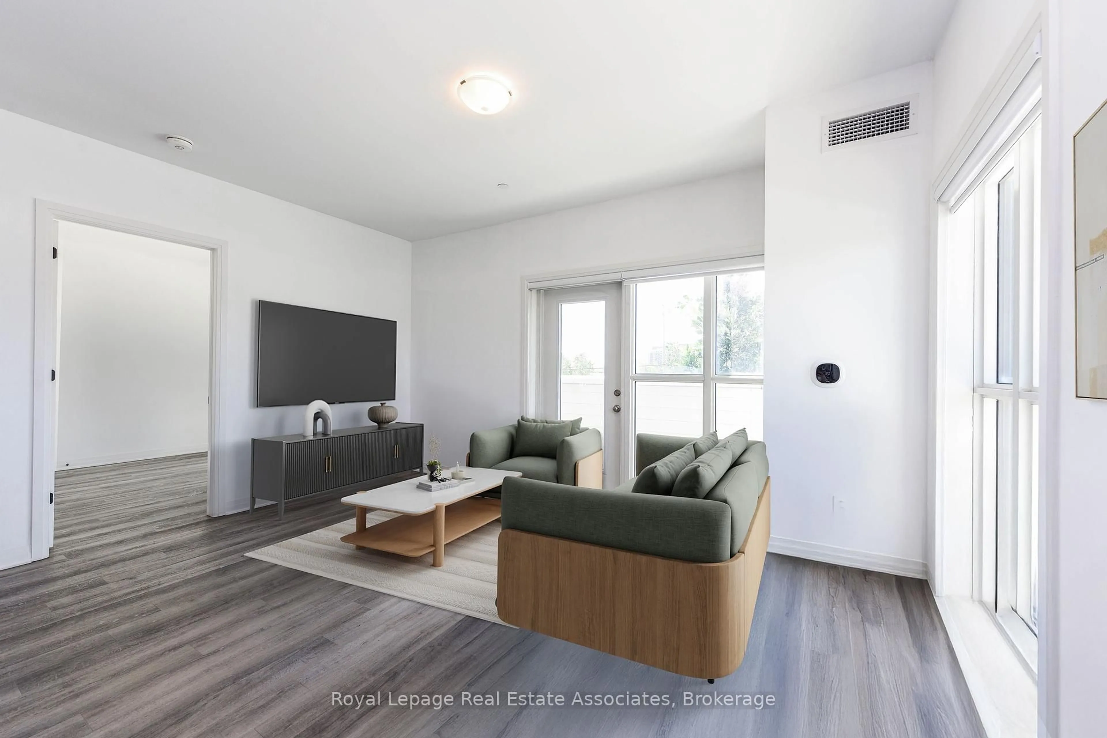Living room with furniture, wood/laminate floor for 102 Grovewood Common #123, Oakville Ontario L6H 0X2