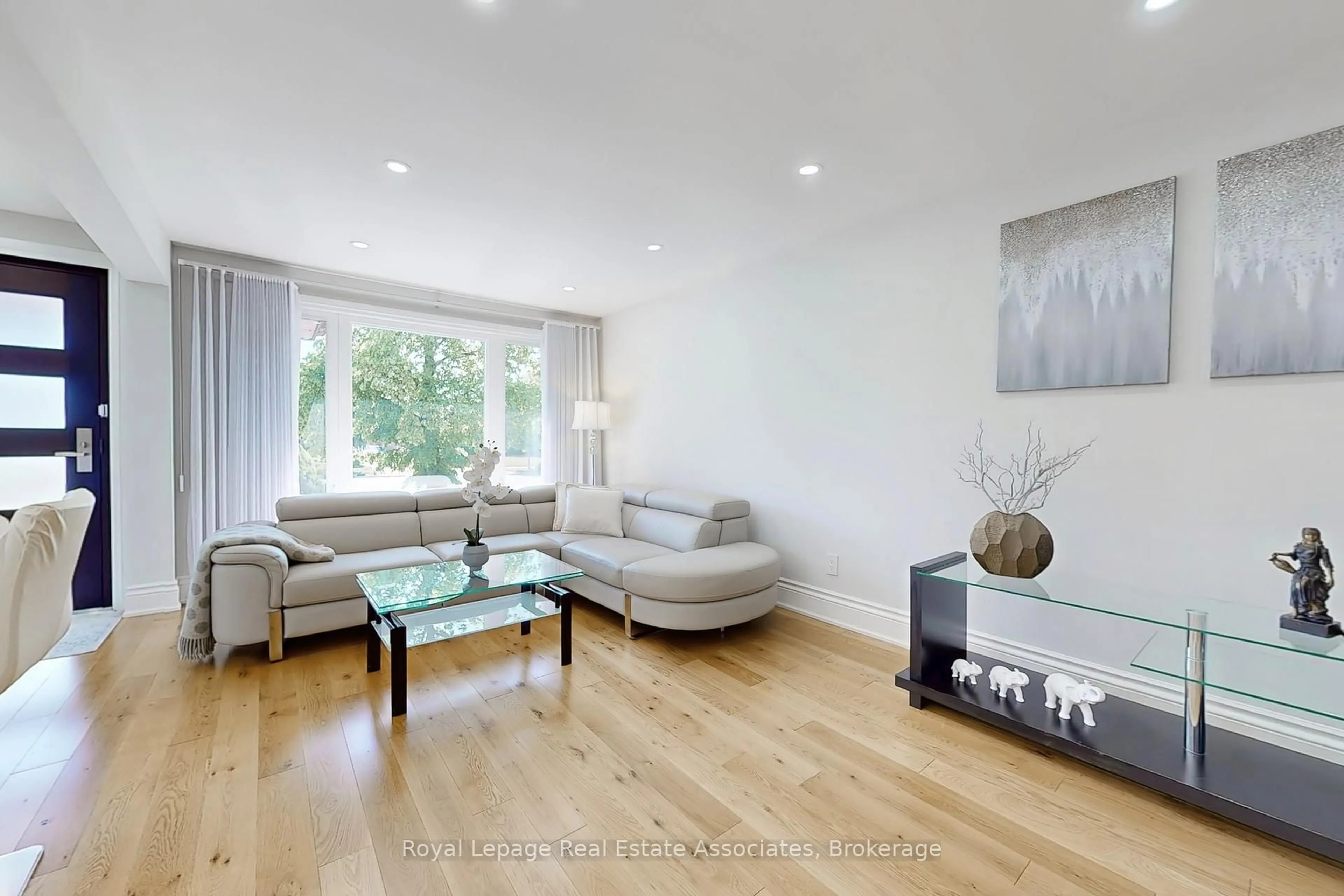 Living room with furniture, wood/laminate floor for 68 Vanguard Dr, Toronto Ontario M9B 5E6