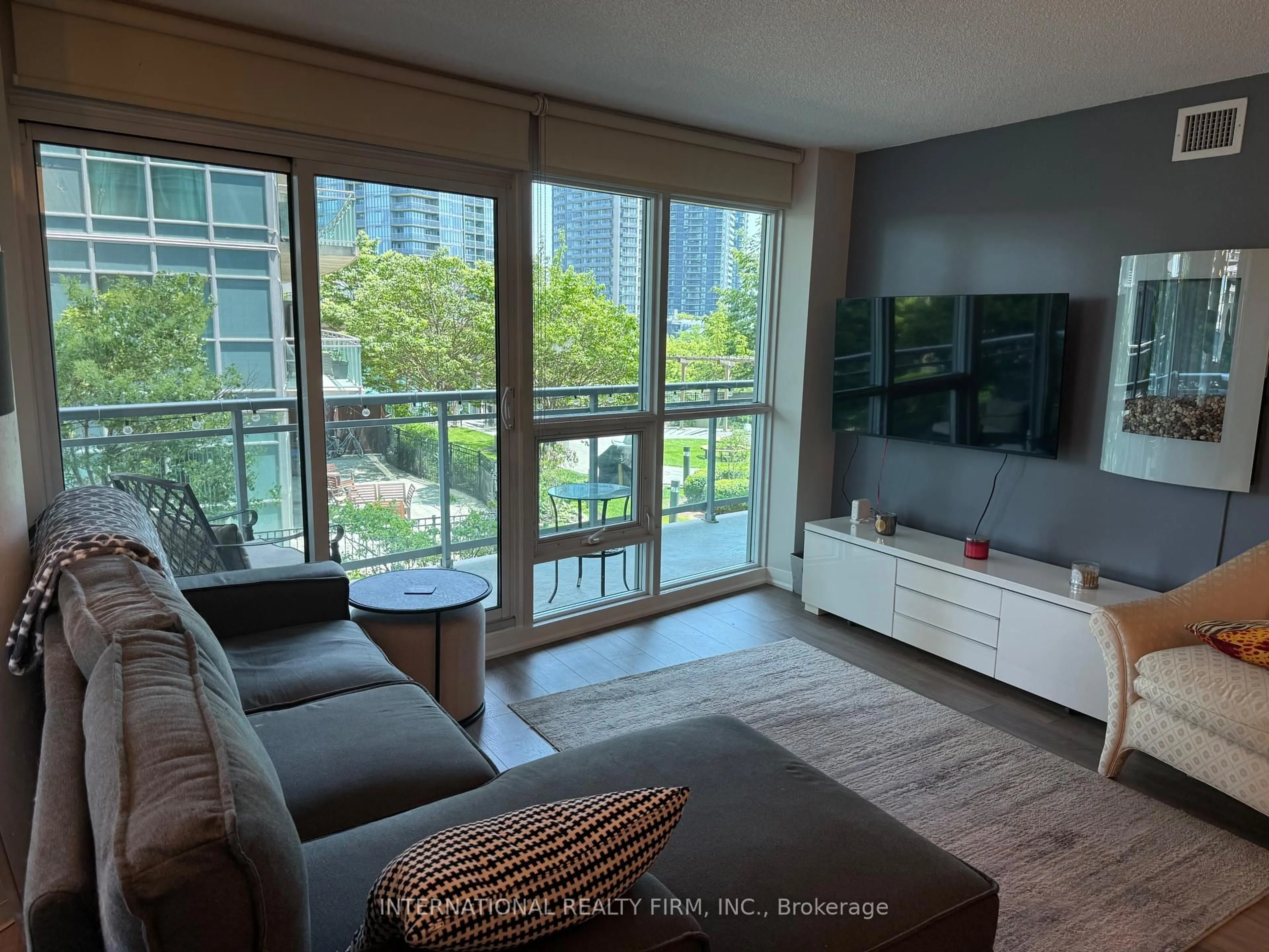 Living room with furniture, wood/laminate floor for 155 Legion Rd #513, Toronto Ontario M8Y 0A7